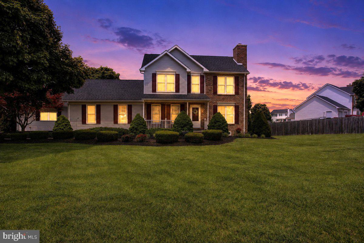 Welcome to this beautiful home in sought after Maugan's Meadows!  Superb curb appeal, large driveway and garage,  landscaping and large deck for entertaining & a convenient location!  The entrance is warm & inviting with a wood burning fireplace in the living room, hardwood flooring, luxury tile & carpet.  Lovely Dining Room &  eat-in kitchen with double sink, granite countertops, island, and real wood cabinets!   The kitchen takes you out to the expansive deck and patio  & yard with hardscape, tasteful landscaping and a fantastic view! The house has an additional family room and bedroom on main level with laundry room and half bath.  Floorplan may easily convert to an In-Law Suite if desired.  Upstairs there are 3 bedrooms with a full hall bathroom & the Master Bedroom has a large closet and spacious Master Bath with separate shower and a soaking tub!  The basement is partially finished with a large rec room, closet, windows, very large unfinished storage room with door and steps out to the back yard.  The unfinished side of the basement has plumbing rough in for any future plans & tons of storage.  The garage has a partial attic with pull down steps & cabinets as well.  Convenient to interstate, schools & shopping! This Home comes with a 1 Year Home Warranty!  Schedule you tour today!