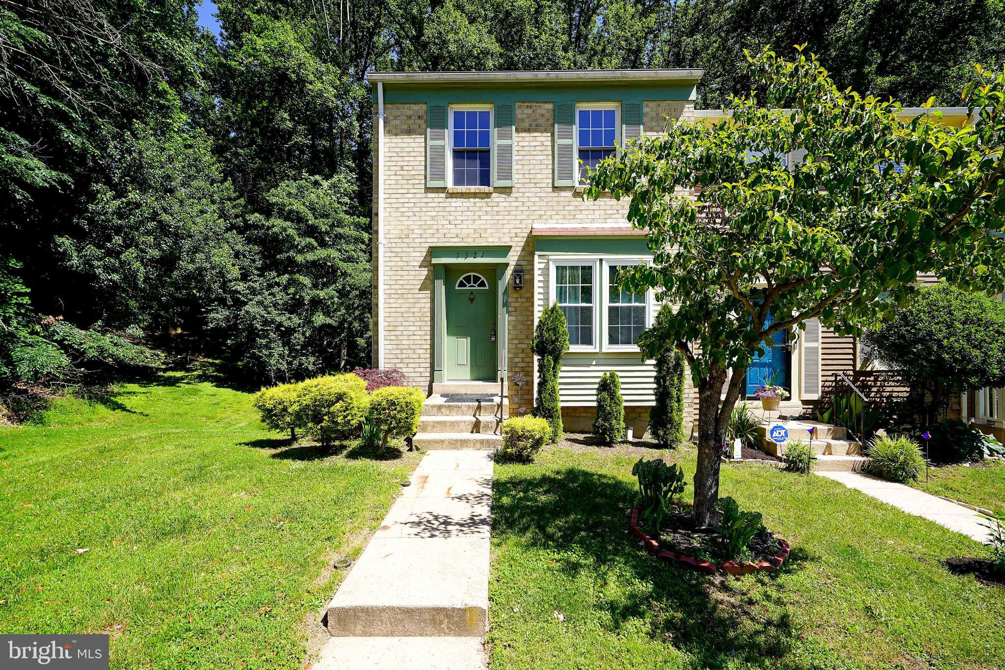 Opportunity awaits in this end-unit townhouse tucked away in a quiet community just off Bonifant Road. Offering 2 spacious bedrooms, 2 full baths, and 1 half bath, this home features a desirable layout with each bedroom boasting its own private en-suite bath and walk-in closet—ideal for roommates, guests, or anyone seeking added privacy. The main level includes an open living and dining area with access to a rear deck overlooking wooded property, while the finished walk-out lower level features a comfortable family room with a fireplace and direct access to a patio and fenced backyard. The wood-fenced outdoor space is perfect for pets, entertaining, or simply enjoying the peaceful setting. A large storage room in the lower level provides exceptional storage space rarely found in similar homes. As an end unit, enjoy an additional window, enhanced privacy, a larger backyard, and only one shared wall. Natural gas heating and cooking offer efficiency and convenience, and the AC unit was replaced approximately 3 years ago. Reserved parking space included. Conveniently located near shopping centers, restaurants, grocery stores, and everyday services. This property is being sold strictly AS-IS, making it an excellent opportunity for investors, renovators, or buyers looking to build equity and customize the home to their taste.