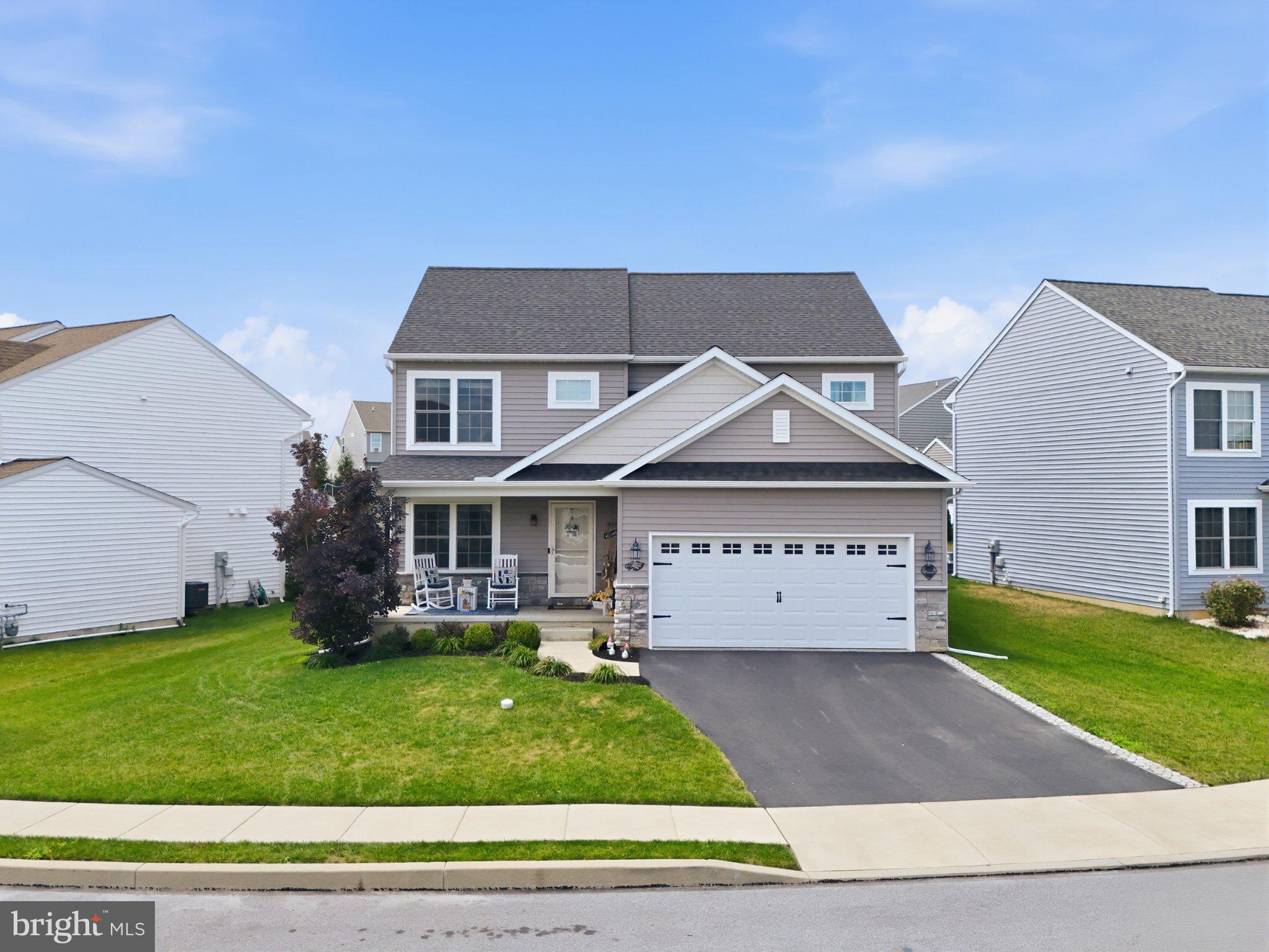 Skip the wait for new construction. Built in 2021 and located in The Landings at Garden Spot Reserve, this exceptional 3 bedroom, 2.5 bath home combines premium builder upgrades with modern style and everyday functionality. The open-concept main level features a stunning kitchen with granite countertops, an oversized island, farmhouse sink, stainless steel appliances, wine fridge and upgraded cabinetry that flows seamlessly into the family room. Just off the main living space, you'll find a beautiful library with custom built-in bookcases perfect for a home office, reading room, or flex space. Upstairs, the spacious primary suite features two walk-in closets and a beautifully appointed en-suite bath, along with two additional generously sized bedrooms. You'll also appreciate the second-floor laundry, conveniently located just steps from all the bedrooms. The partially finished basement provides the perfect space for entertaining, a playroom, or home gym with the gym equipment included while the unfinished portion offers plenty of additional storage. Outside, relax on the covered patio complete with a built-in TV and dedicated gas line for effortless outdoor grilling, all overlooking one of the better lots in the community. Skip the wait and expense of new construction. This home has already been thoughtfully upgraded and is ready for you to enjoy from day one.