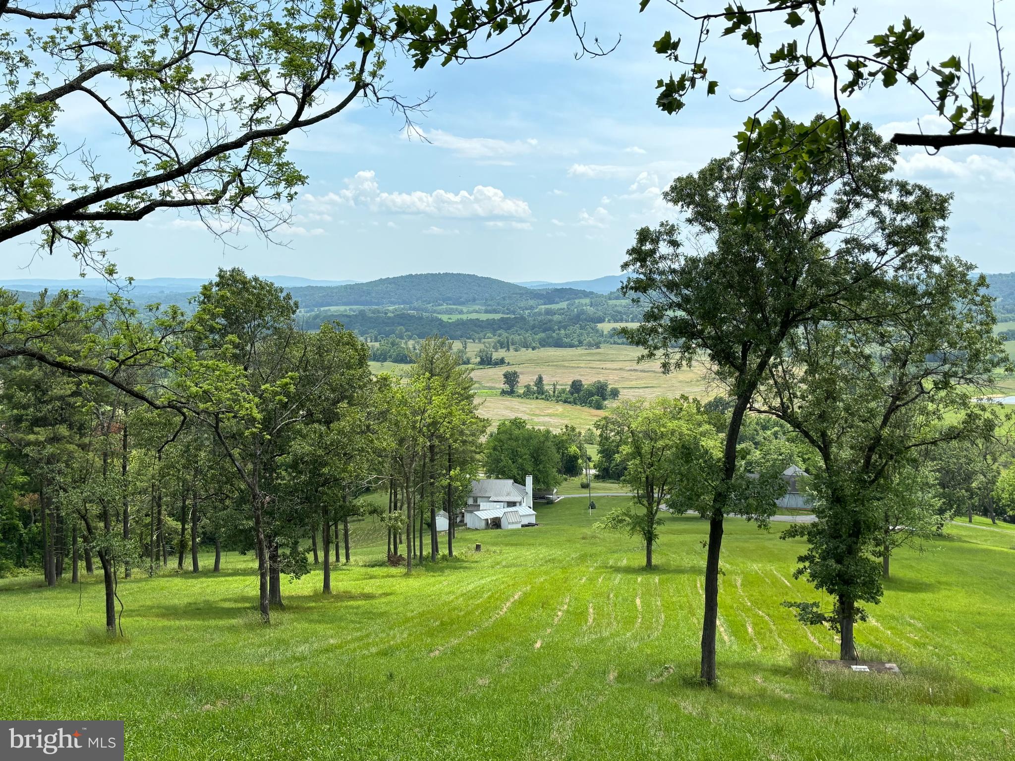 “Paris from Above”. Opportunity to own a legacy property with conservation easement potential--notably this is the gateway to the Paris Valley.  Enjoy unimaginable, far-reaching views from this home located above the historic hamlet of Paris, Virginia.  Across the stunning hillside meadows there are plenty of enchanting additional building sites for your new home. There are 7 divisions allowed by right.  Mature trees, rubble stone walls and abundant wildlife are found here. The property, located west of Middleburg and Upperville,  is easy to access from multiple directions.  Perfectly poised for  pursuit of an agribusiness/farm winery or brewery.  As a single unit, the total 47 acres represents an unparalleled situation to create a one-of-a-kind family compound, country home or hunter's wildlife paradise, enjoying vantage point views like no other.  The listing includes 3  adjoining parcels (6.1 acres,  20.28 and 21.47 acres).  Good soil, south facing slopes and siting make this an attractive location for vineyards. Located at the landmark intersection of John S. Mosby Highway (Route 50) and Route 17,  the location is strategic for a farm winery, farm brewery or other agribusiness.  The property has extensive frontage on U.S. Route 50 with several entrance points.  The property is situated amidst a variety of protected, conserved lands which contribute to its conservation value. Piedmont Environmental Council and Virginia Outdoors Foundation easements protect over 1,500 acres in the area.  Sky Meadows State Park of 1,826 acres and the G. Richard Thompson State Wildlife Management Area, consisting of 4,000 acres, are nearby neighbors. A launch station for the Appalachian Trail is across the road. The Shenandoah River is two minutes away. There is  a charming, renovated two story, 3 bedroom, 2 ½ bath home, a 6,000 sq ft bank barn/equipment storage building/shop, several storybook outbuildings (for storage, potting and gardening, farm animals, art studio or office—Think author, Bunny Williams’ book, “An Affair with a House”).  Relax on wraparound porch--enjoy unmatched views. The house is graced with antique hardwood floors and has a period feel.  High speed broadband internet!  The  6,000 sq ft  barn sits apart from the home with ample parking on all sides with separate driveway. The well-constructed block and board and batten building has a large workshop with restroom and 8 bays on one level of the building. Generous area for farm equipment, car collection, or your other hobbies. On the other side of the building are two secure storage rooms and huge  space with high, raftered ceilings. The building has been recently enhanced with a 220v RV hookup. Live in the existing home during construction of your new home and use the large barn as the base of operations for the construction crew and fabrications!  Conservation  easement potential exists. Development potential exists. The land offers 7  by right divisions. Many varied opportunities await your imagination. Appt only. No drive ins. Don't miss drone video at  video icon. See companion listings for alternate packaging of this property: VAFQ2012274 and VAFQ2012306.