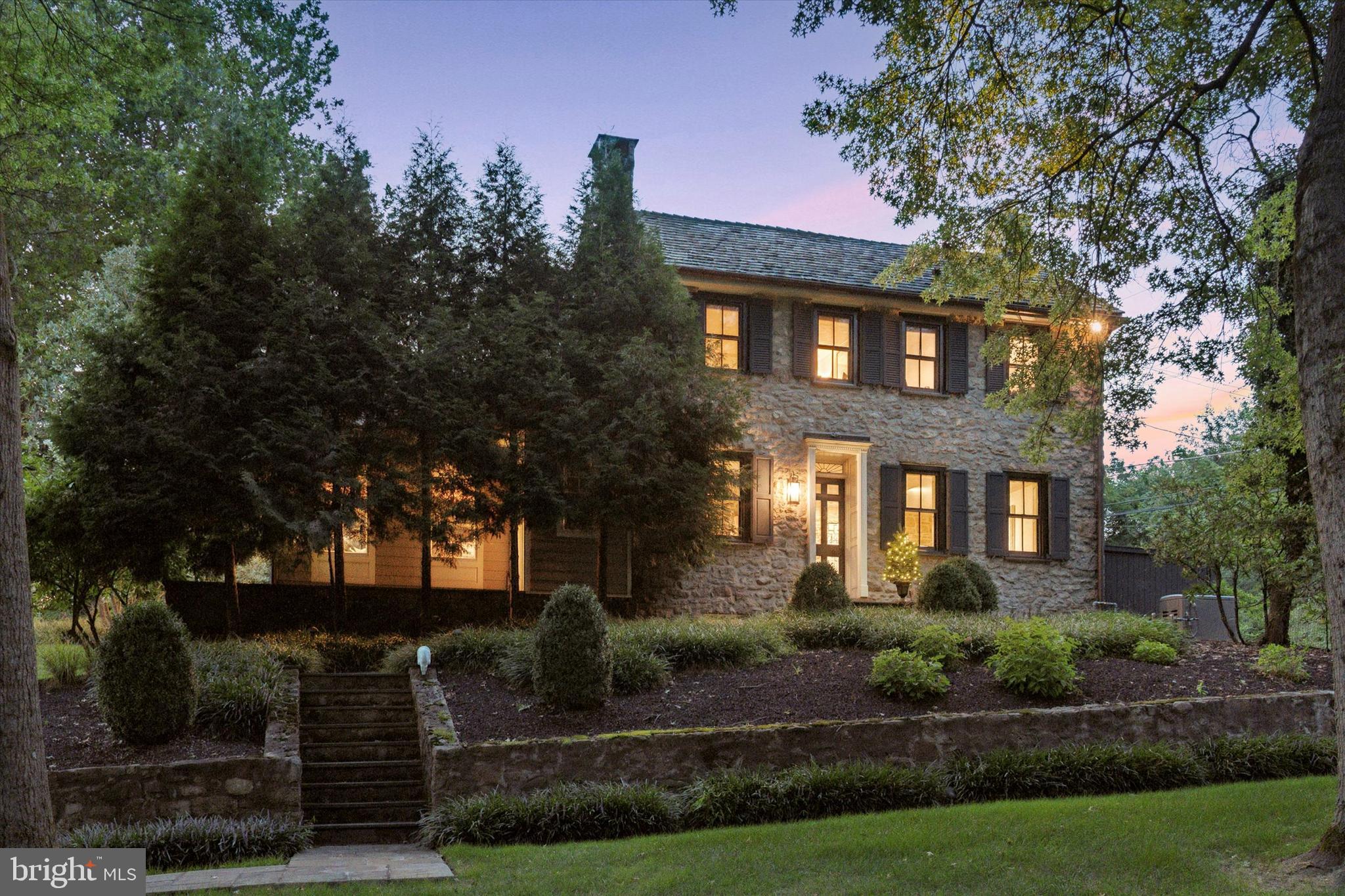 Nestled on nearly two serene acres, Beech Tree Ridge is a stunning c. 1800 Bucks County stonehouse that embodies a perfect blend of historic charm and modern luxury. Located in the highly sought-after Buckingham Township, this exquisite property offers easy access to the historic Doylestown center, Peddlers Village, and the scenic river towns of New Hope and Lambertville.

Beech Tree Ridge boasts one of the most picturesque settings in Bucks County. Every time you pull into your driveway you should fall in love with your home and this is the Bucks County house you have been dreaming of! The meticulously maintained stone farmhouse features beautifully pointed stone walls, seamlessly blending authentic details with significant modern updates. The heart of the home is a fully fitted, eat-in chef’s kitchen, complete with a spacious brand new solid walnut center island island, 48-inch Wolf range, Sub-Zero refrigerator, and Bosch dishwasher. The kitchen flows effortlessly into a large family room adorned with custom cabinetry, a Scandinavian woodstove, a dramatic two-story stone wall, and wrap-around windows that offer stunning views of the ever-changing landscape. Great outdoor living set up with a heated pool, kitchen w/ grill, refrigerator, wet bar and exhaust fan. Outdoor sonos speakers as well and a walking trail along the back of the home. Irrigation system helps keep the property green and lush in the hot summer days. 

The generously sized dining room, featuring an exposed stone wall and original stone fireplace updated with a natural gas freestanding hearth, is perfect for hosting gatherings. Do not forget to check out the repurposed "front door". Upstairs, the home offers three bedrooms and 2 full bathrooms, each showcasing the home's signature stone walls and deep-set window sills that enhance its old-world allure. The main bathroom has been fully remodeled with tile throughout along with restoration hardware, plumbing and vanity. New Anderson windows all installed in the main part of the original home along with beautiful custom copper gutters and downspouts.

A short stroll down a beautiful Blue Stone walkway leads to the c. 1800 bank barn, which has been thoughtfully transformed into a guest house. This inviting space features a vaulted ceiling, two-story windows in the media/gathering room, a separate dining room, a large bedroom, and a great room/office ideal for remote work or study. The guest house also includes a luxurious bath completely renovated head to toe. There is central air, a kitchenette and more storage. This bank barn is a highly sought after Airbnb that books very quickly and is an integral part of this property.

There are two generously sized garages. The modern, approximately 1,100 sq. ft. garage offers 18+ foot clearance, making it ideal for adding a car lift or storing inventory for a home business. Ev Charging for your electric cars. This space in the past has been utilized as an air-conditioned exercise area, office space, storage and seasonal pickle ball court. The second garage, designed with extra depth and width, accommodates two large vehicles and offers additional storage space in the unfinished attic above. Be sure to check the basement of the bank barn which would be an amazing wine cellar, crafts room and much more.

The owners really did a great job caring for, updating and maintaining this one of a kind beautiful property. Schedule your showing today to tour the quintessential Bucks County lifestyle at Beech Tree Ridge, where timeless elegance meets modern convenience.