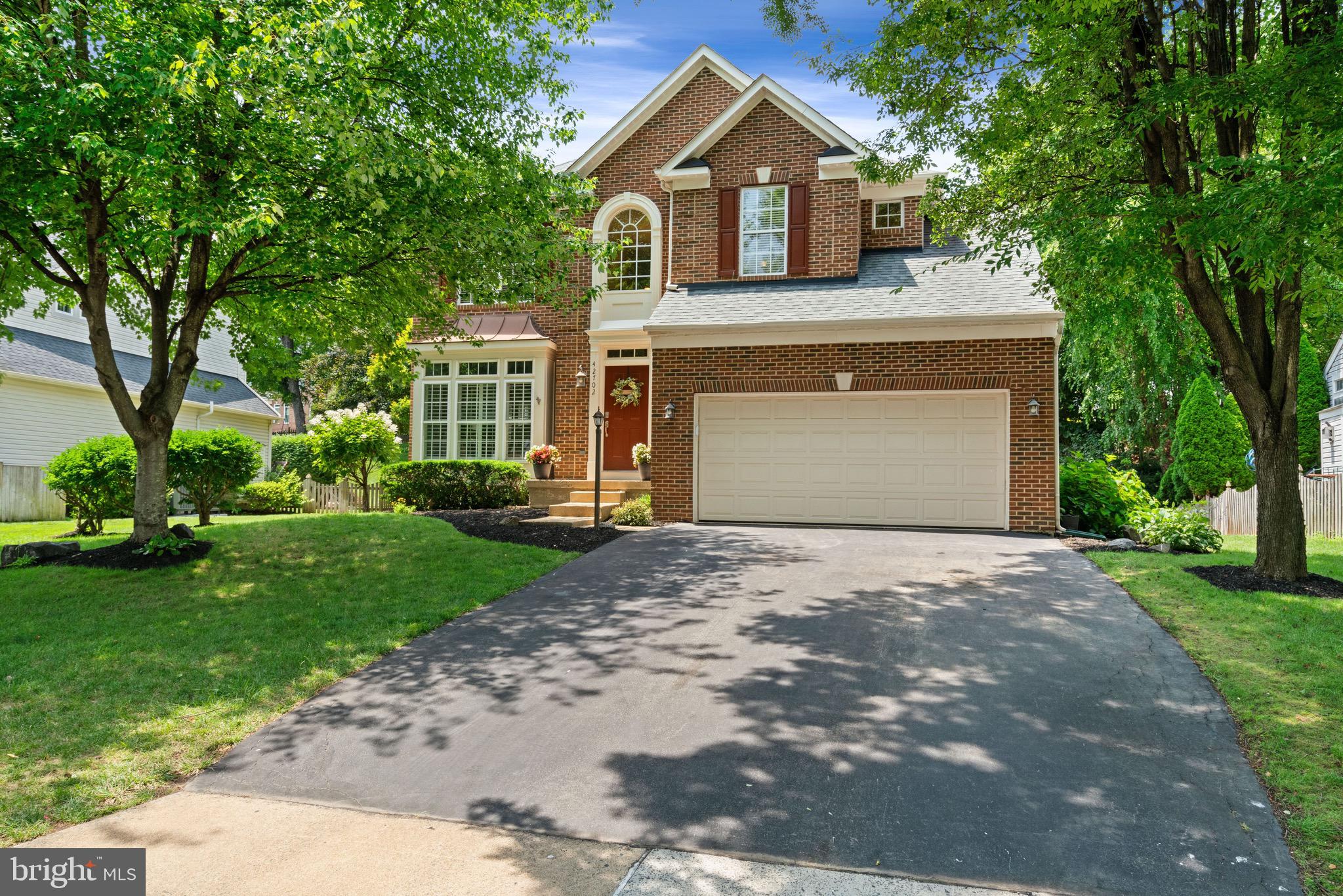 Classic architecture, timeless finishes, and sun filled living spaces set the stage for a home that feels both elegant and effortlessly livable. Beautifully maintained and thoughtfully updated, this exceptional residence offers four upper level bedrooms, three-and-a-half bathrooms, a two car garage, and a floor plan designed to balance refined entertaining with comfortable everyday living.
<br><br>
A dramatic two story foyer creates a memorable first impression, welcoming you into interiors enhanced by rich hardwood flooring, detailed trim work, and plantation shutters throughout the main level. Formal living and dining rooms provide elegant spaces for hosting holiday celebrations and special occasions, while abundant windows fill the home with warmth and natural light.
<br><br>
The inviting family room is anchored by a cozy gas fireplace, creating the perfect gathering place for relaxing evenings or spending time with family and friends. Just beyond, the gourmet kitchen is thoughtfully designed for both everyday living and entertaining, featuring granite countertops, upgraded stainless steel appliances, a center island, pantry, gas cooking, and abundant cabinetry. A sunny breakfast room overlooks the backyard, providing the perfect setting for morning coffee and casual meals. A conveniently located main level laundry room adds everyday functionality and includes a new washer and dryer installed in 2026.
<br><br>
Upstairs, the spacious primary suite offers a peaceful retreat with plush carpeting and an elegant tray ceiling. The beautifully renovated primary bathroom, completed in 2024, creates a spa inspired escape with a freestanding soaking tub, an oversized frameless glass shower with a rainfall shower head, designer fixtures, and thoughtfully designed built in storage. Three additional bedrooms are generously sized, each offering plush carpeting, ample closet space, and access to the beautifully updated hall bathroom.
<br><br>
The fully finished walk up lower level provides exceptional flexibility for today's lifestyle. Spacious recreation areas easily accommodate movie nights, game days, fitness equipment, or entertaining, while a private den offers an ideal home office, hobby room, or guest space. A renovated full bathroom features an impressive oversized walk in shower with a luxurious rainfall shower head.
<br><br>
Significant recent improvements include a new HVAC system (2021), luxury vinyl plank flooring throughout the lower level, a new water heater (2024), a beautifully renovated primary bathroom (2024), and numerous 2026 updates including a new refrigerator, dishwasher, washer, dryer, and updated lighting throughout the hallways.
<br><br>
Step outside to discover a private backyard designed for both relaxation and entertaining. Extensive hardscaping and attractive retaining walls frame the paver patio, creating the perfect setting for outdoor dining, summer gatherings, or quiet evenings beneath mature shade trees. Professionally landscaped grounds complete this peaceful outdoor retreat.
<br><br>
Life in Broadlands offers the perfect blend of recreation, convenience, and community. Residents enjoy multiple swimming pools, a fitness center, tennis and pickleball courts, miles of scenic walking trails, playgrounds, community events, and beautifully preserved green spaces, all just minutes from Broadlands Village Center, top rated schools, the Silver Line Metro, major commuter routes, shopping, dining, and Dulles International Airport.
<br><br>
Beautifully updated, meticulously maintained, and thoughtfully enhanced over the years, this exceptional home offers timeless style, modern comfort, and an outstanding lifestyle in one of Loudoun County's most sought after communities.