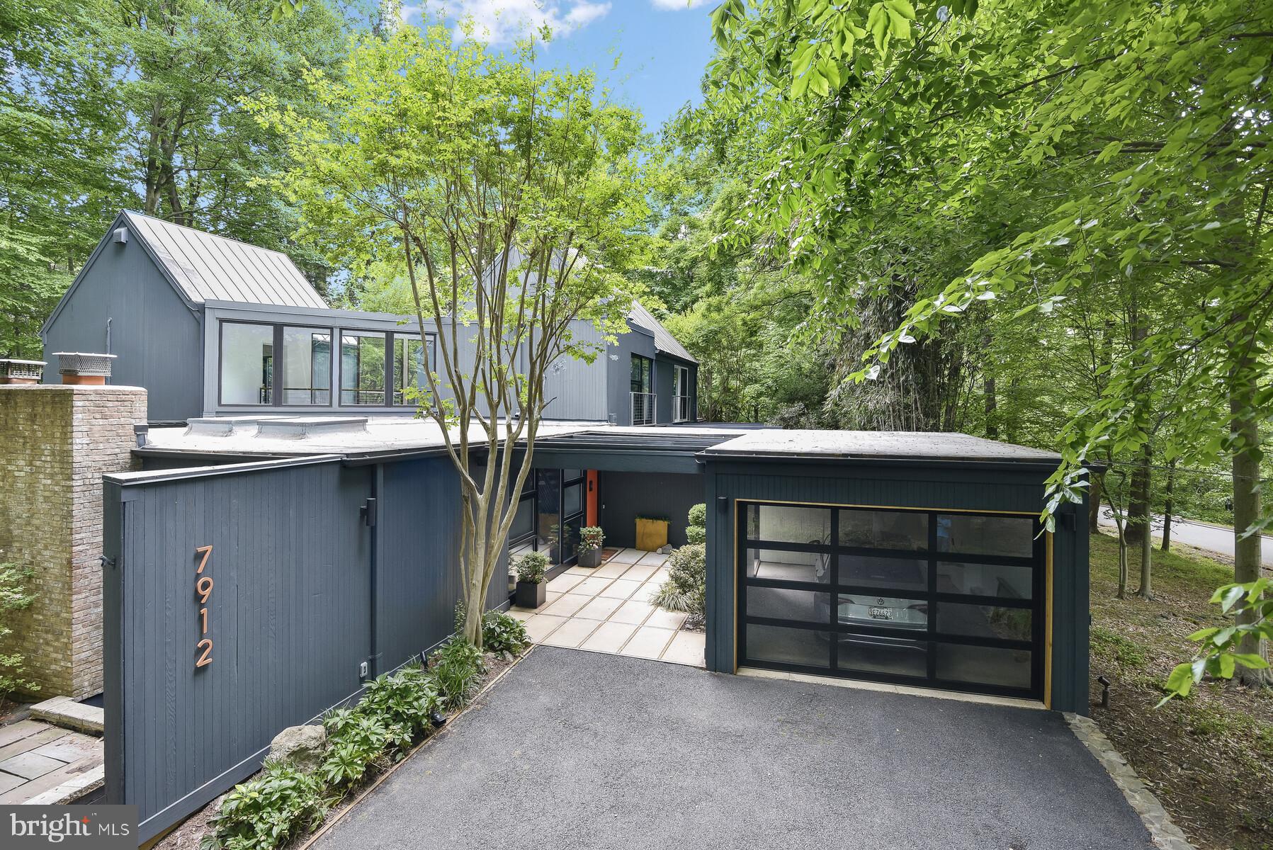 **Open House Cancelled, Offer deadline set for Sunday, 6/18, at 6 PM**Exquisitely crafted and thoughtfully renovated, 7912 Deepwell Drive stands as a celebrated masterwork of mid-century modern architecture, nestled upon a sprawling .67-acre estate in an esteemed Bethesda enclave. Tucked away amidst tranquil surroundings, this custom retreat, designed by award winning architect Walter Dodd Ramberg, ensures the utmost in privacy and serenity. Residents are greeted by a pergola covered entry walkway as they are ushered into this whimsical and light-filled sanctuary showcasing a handsome slate floored Foyer with dramatic catwalk above and eye-catching floating stairs to the Upper Level. Additional details of gleaming hardwood floors, multiple skylights and walls of windows, floating walls, striking angles and perfectly curated modern fixtures are artfully displayed in an open plan. Indulge your culinary desires with the Main Level’s gourmet Kitchen, adorned with handsome tiled floors, bespoke European cabinetry, state of the art appliances, concrete counters and a seamless transition to the pool terrace through sliding glass doors.

This harmonious blend of functionality and style is further enhanced by an inviting Family Room also with access to the pool terrace as well as a second patio area, a private Office, Main Level Guest Quarters with en suite bath as well as a generous Laundry Room/Butler’s Pantry adjacent to the Kitchen. Ascend to the captivating Primary Bedroom Suite highlighted by a Roof Terrace for the height of relaxation. The primary Bedroom boasts a cathedral ceiling and loft space above as well as a fully renovated bath and dressing area. Completing the Upper Level are two additional bedrooms, each thoughtfully designed to provide luxurious comfort and timeless allure, taking full advantage of the stunning natural views from each bedroom. The multifunctional Lower Level provides opportunities to finish the space to suit one’s needs, whether it be Gym Area, Wine Cellar or additional recreation space. The beauty of 7912 Deepwell Drive expands to a captivating slate pool terrace, inviting heated pool, two additional patio areas as well as a walled courtyard, all embraced by meticulously landscaped grounds, creating the ultimate private and idyllic escape.
