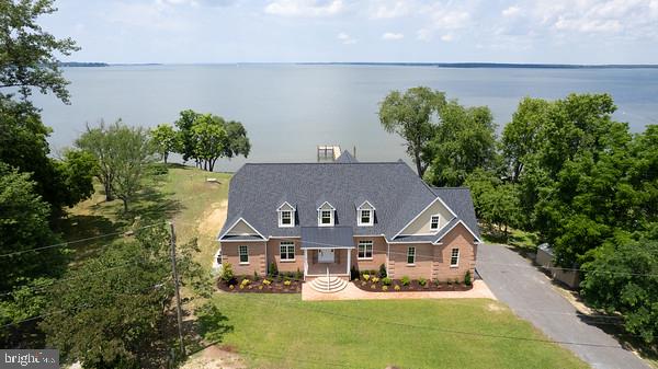 Welcome to Your Waterfront Paradise! 

Indulge in the ultimate coastal lifestyle with this luxurious brand-new home boasting breathtaking sunsets and sunrises over the Choptank River. Spanning over 5,000 livable square feet, this masterpiece offers every amenity imaginable, ensuring comfort, style, and convenience.

* Prime waterfront location with unparalleled views of the sun setting and rising over the horizon.
* Spacious 5 bedrooms 3 full and 2 1/2  bathrooms, providing ample space for family and guests.
* Large oversized 2-car garage, perfect for storing vehicles, watercraft, and outdoor gear.
* First and second-floor living rooms, offering versatile spaces for relaxation and entertainment.
* Patio access to a charming sitting room, ideal for enjoying the serene waterfront atmosphere.
* Brand new kitchen with elegant granite countertops, state-of-the-art appliances, and abundant storage.
* Private 100-foot pier with water and power, providing direct access to boating, fishing, and water activities.
* Classic brick front, exuding timeless charm and durability.
* Luxurious walk-in closets ensuring ample storage and organization.
* Marvin coastal windows, engineered to withstand high winds while maximizing natural light and views.
* High-efficiency dual fuel heating system, ensuring comfort and energy savings year-round.
* Inviting gas fireplace, perfect for cozy evenings by the water.
* Stunning white oak hardwood flooring throughout, adding warmth and sophistication.
* Convenient butler's pantry, enhancing organization and entertaining capabilities.
* Spacious layout with ample room for living, dining, and entertaining, making it perfect for gatherings of any size.
* Located close to downtown Cambridge and all it has to offer. 

Don't miss this rare opportunity to own your waterfront dream home.