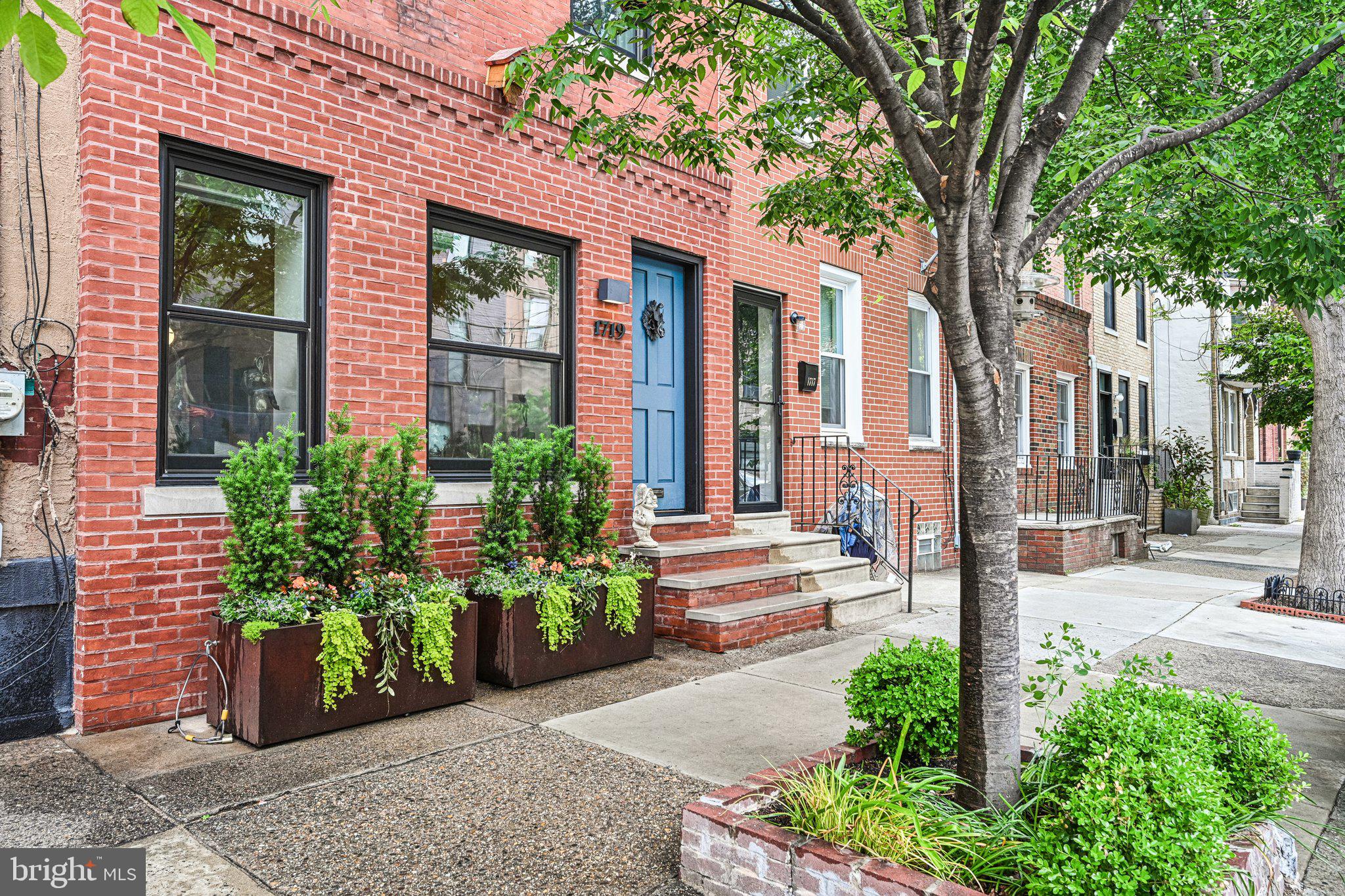 Nestled in the highly sought-after Graduate Hospital neighborhood, this stunning rowhome offers breathtaking, unobstructed views of the Philadelphia skyline along with thoughtfully designed living spaces and modern smart home features throughout. Enter through the welcoming foyer into an open-concept main level where the living room flows seamlessly into the dining area opening into the kitchen, creating the perfect layout for both everyday living and entertaining. The bright kitchen is outfitted with fresh white cabinetry and countertops, complemented by large windows that flood the space with natural light. Sliding glass doors lead to a private, peaceful rear patio, while a convenient powder room completes the first floor. The second level features two spacious bedrooms, including one with its own adjoining sitting room—ideal for a home office, nursery, or cozy retreat. A full hall bathroom and conveniently tucked-away laundry closet complete this floor. Occupying the entire third level, the luxurious primary suite offers a private sitting area, a walk-in shower and water closet, and sliding doors leading to a rear deck showcasing spectacular city skyline views. Freshly painted and equipped with smart home technology throughout, this exceptional home combines comfort, style, and convenience in one of Philadelphia’s most desirable locations. Perfectly situated with the YMCA directly across the street and Rittenhouse Square just a few blocks away, this is city living at its finest.