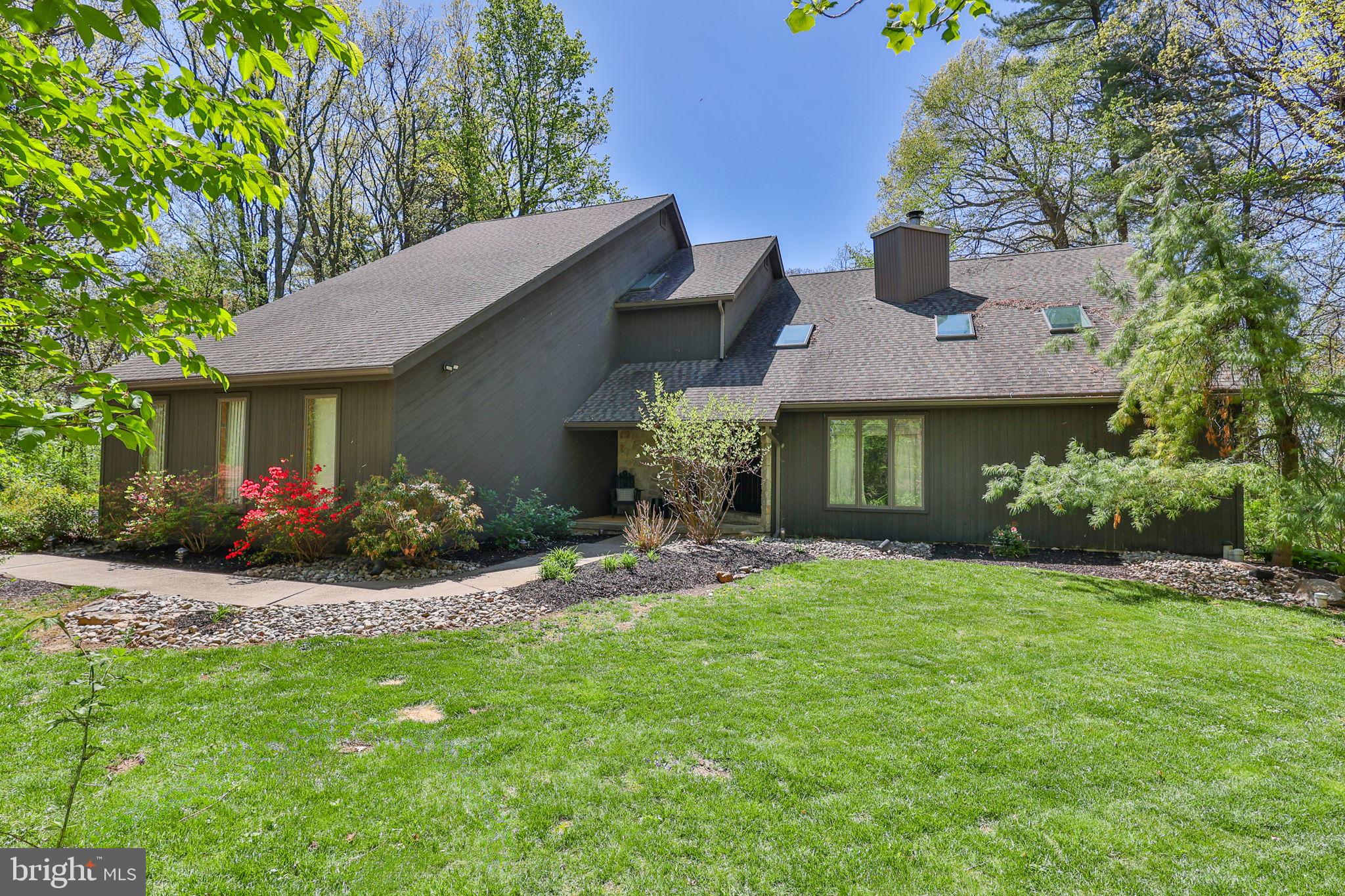 A truly exceptional find...resort-style living on 2.6 wooded acres in Moore Township...where privacy, luxury & lifestyle come together in this unforgettable setting. Minutes from routes 512, 248, 33 & 946, this stunning contemporary home was created for  entertaining both indoors & out. This warm & sophisticated 4 Bedroom home offers abundant natural light, an open floor plan, generously sized rooms, a 3-car garage, 3 fireplaces plus 3 full Baths. The Kitchen is perfectly situated & flows seamlessly into the family room offering plenty of counter space, a wine fridge to store your collection & amazing outdoor views. The basement features office space, tons of storage plus a spacious rec room--pool table included! The primary suite is a retreat of its own with vaulted ceilings, a gas fireplace & 2 walk-in closets.
Step outdoors & see what sets this property apart! The spectacular backyard is designed for relaxation & entertaining. Enjoy the Summer by the pool, unwind in the 8 person hot tub, or catch the chill vibe by the koi pond. The sprawling wraparound deck is surrounded by nature & offers views of preserved farmland--increasingly elu