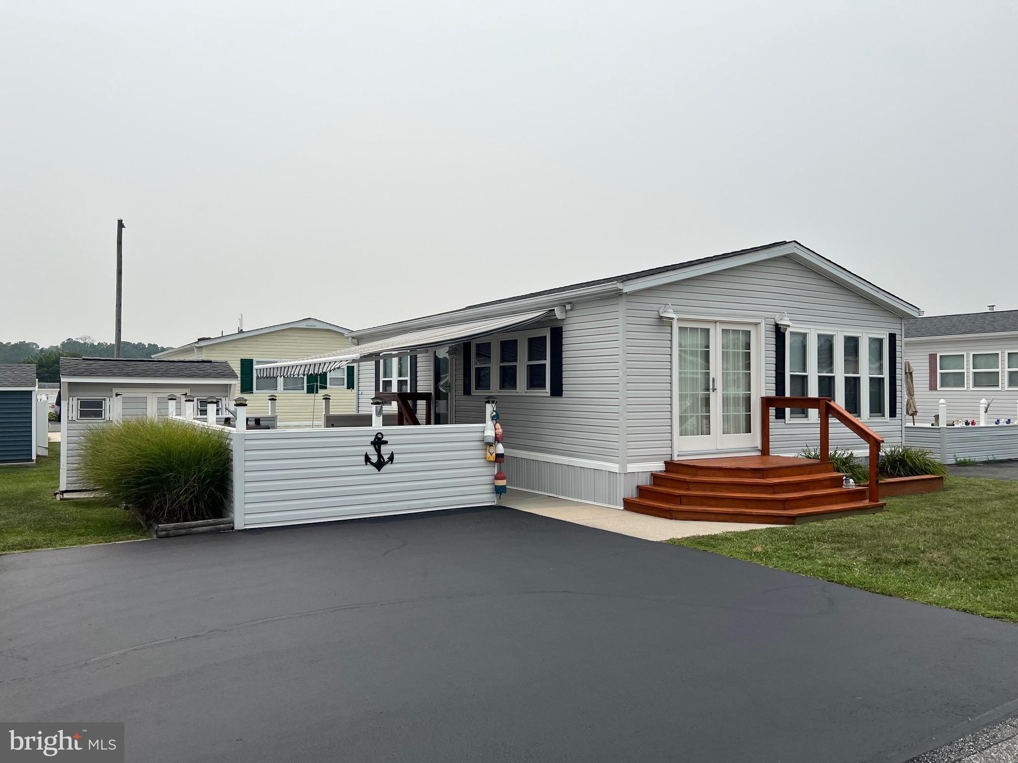 Immaculate Turn Key 2 Bedroom Cottage! Updates include: Plumbing, Roof, Windows, Doors & AC!  This Home is Move in Ready with Spacious Open Concept Living Area. Lots of Storage & Built-ins in Both Bedrooms. Washer/Dryer, Built in Microwave, Power Retractable  Awning, Courtyard  & Shed with Electric.