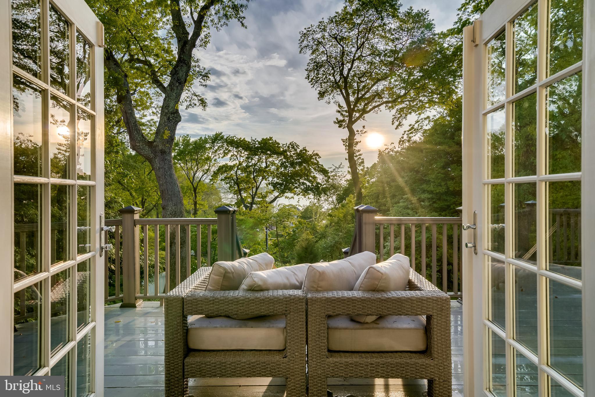 Step into your Coastal Cape Cod style beach home in the coveted community of Round Bay that overlooks the Severn River! What once was an 80-year-old small cottage home is now a beautiful 4 bedroom, 4.5 bath home with a total of 5,360 Sq Ft. Rebuilt in 2000, this home kept several features to preserve the original home's charm and character like the front porch that has the original pine flooring, the original back door of the home that is now used as the door to the wine cellar, and the original chimney that was restored with stone veneer. The main level of the home contains beautiful Brazilian cherry floors, a desirable floor plan, and a stunning kitchen that features granite counters, cherry cabinets, a large eat-in island, and Jenn Aire stainless appliances. The kitchen leads you into the spacious family room with large windows and French doors that open up to your large private deck. The home is perfectly seated atop a gentle hill, so you will enjoy the most beautiful views of the Severn River and exquisite sunsets every night. Nestled among trees, the backyard is very private and makes this home a rare and beautiful retreat! The family room is adjacent to the formal living room with a wood-burning (gas-assisted) stone fireplace. It is located near the home office with built-in shelving, large windows, and gorgeous views of the Severn River that will make you feel like you're working while on vacation every day! Heading upstairs, you will find the spacious sun-filled master suite that boasts vaulted ceilings, recess lighting, and French doors that lead you out onto your private balcony with views of the River. The ensuite master bath features a jacuzzi tub, a glass-enclosed stand-up shower, and 2 vanities with a makeup station. Heading to the third level, you will find a fully finished open space with a full bathroom and River views, perfect for a guest room. The fully finished walk-out basement boasts a large storage room and a wine cellar.  Rest assured your family will remain comfortable in any weather with a backup generator that can run the whole home. The beach and Round Bay amenities are mere steps away! Enjoy two beaches, 3 piers, boat slips (available upon waitlist) and mooring balls, tennis courts, a pavilion, canoe, and kayak racks, picnic areas, and a tot lot- all just 3 minutes from the house. The Round Bay community is a highly desirable waterfront neighborhood with an award-winning school system and an easy commute to Annapolis and Washington DC. Don't miss an opportunity to live in the perfect home in an ideal location that will make you feel like you are on vacation every day!