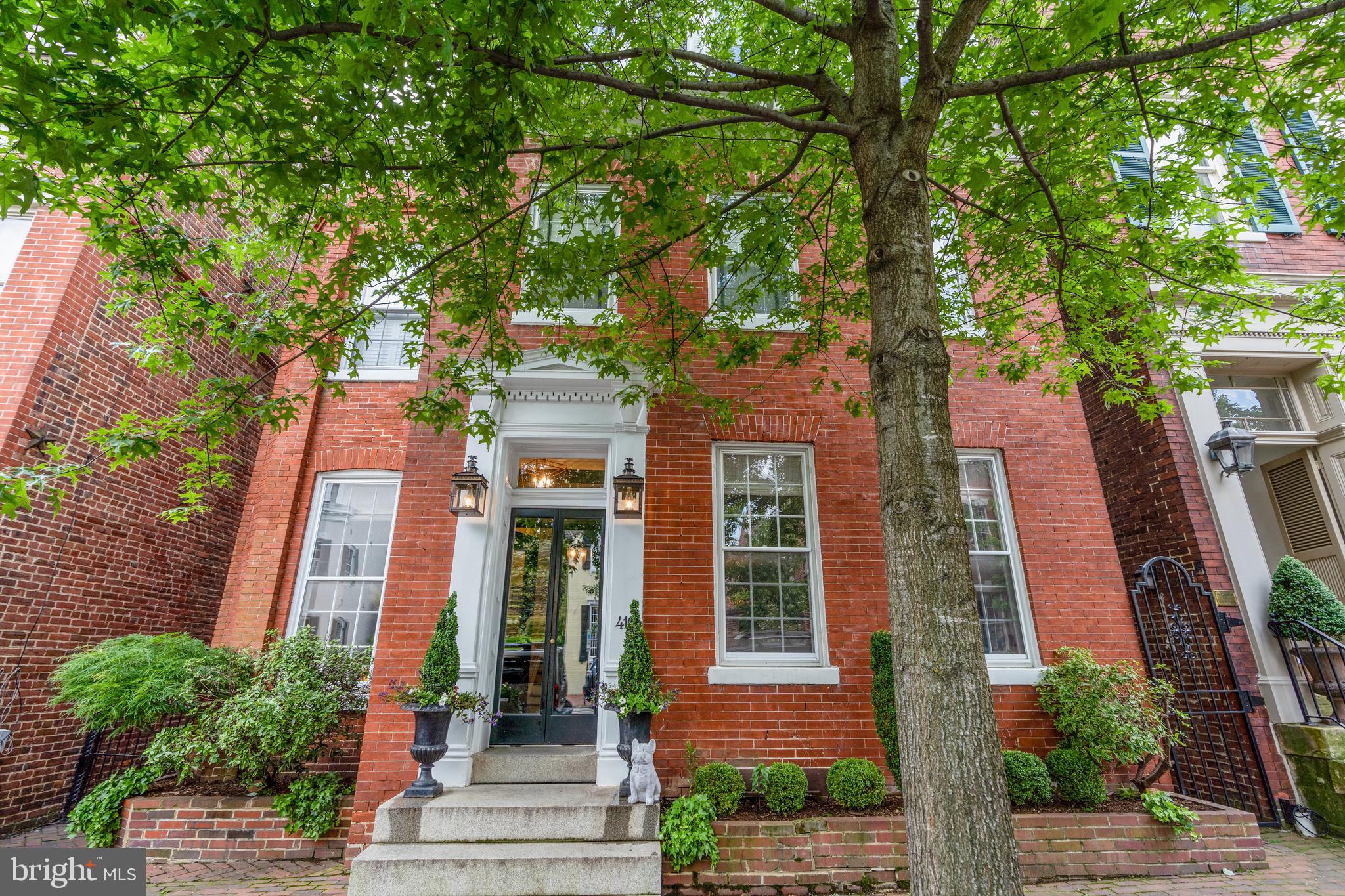 Built in 1800, this detached, Victorian masterpiece is located on a picturesque street in the heart of Old Town Alexandria. Boasting unparalleled curb appeal, this historic home features versatile living spaces and modern amenities for easy living. The classic vestibule entry welcomes you into a spacious foyer and sitting room with access to the lovely, screened porch privately located on the side. Generously sized living and dining rooms adorn the front of the home are perfect for entertaining or casual enjoyment.  A half bath, wet bar and coat closet and are discreetly tucked away beyond the formal living spaces.  The back of the house offers a sought-after family room, kitchen and sunroom or breakfast room perfect for practical everyday use. The upper level encompasses 4 spacious bedrooms, 3 en suite baths, a den, an office and a chic laundry room with a utility sink and storage. The finished lower level is a bonus recreation room or gym with additional storage. Access the beautiful private garden from the back alley, side gate, family room or breakfast room! A fabulous space for entertaining, the sizable yard affords abundant possibilities. Leave your car at home in the off-street parking space and enjoy walking to all the delights of Old Town. Located just steps from the Mt. Vernon Trail, the Potomac River, shops and restaurants on King Street, and easy access to National Airport, Metro, Amazon HQ2, and major commuter routes this is a one-of-a-kind home not to be missed!