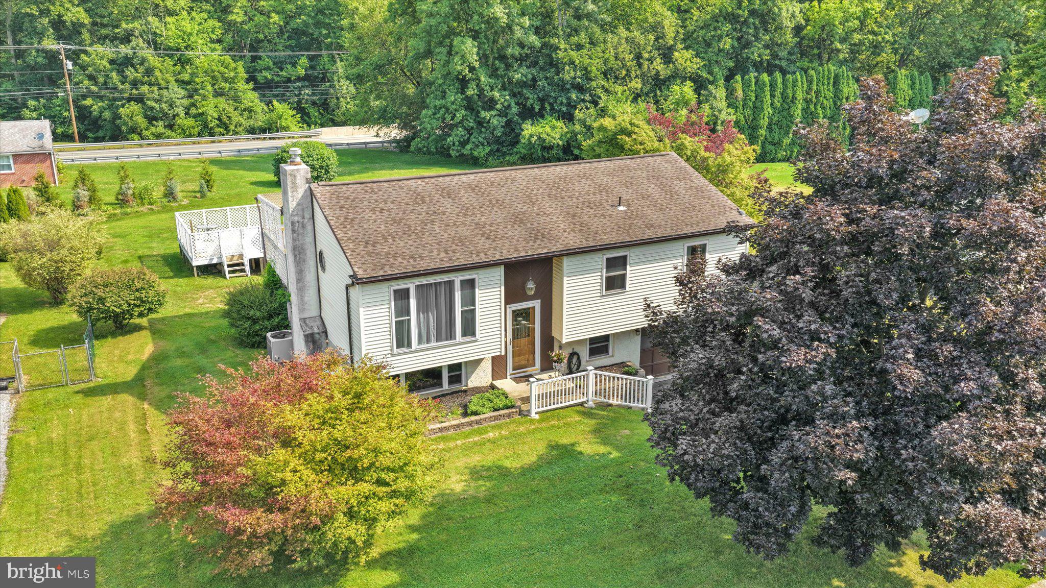 Welcome to 47 Carriage Circle in Oley Township's "Charmingdale" community. This Oley Valley Schools 3 bedroom, 2 full bath bi-level style home offers 2276 square feet of absolute move in ready living area. Take the half set of stairs up to the main living area where you'll love the open floor plan with beautiful oak hardwoods in both the spacious living and dining rooms. Dining room features a built-in with granite tops serving bar hutch that matches the custom kitchen.  The sure to please newly remodeled 50 handle white kitchen is where you'll enjoy preparing those family holiday dinners. Features include granite tops, tile backsplash, soft close drawers and doors, recessed lighting and double wall ovens complete the upgraded stainless steel appliance package. Sliders off the dining room lead to the covered rear deck - a great spot for all year grilling. Take the hall back to the 3 generous sized bedrooms and the updated full tub/shower hall bath with additional private access to the master bedroom. Take the stairs to the oversized family room with propane gas fireplace and custom corner bar area remains. A second full stall shower bath with laundry area completes the lower level. All this plus a 1 car attached garage, a nice .23 acre lot that backs to community common area, an above ground pool with deck (closed but needs new liner and cover) and close to schools, dining, the Oley Fairgrounds and Youth League making this the one to see! Schedule your showing today!