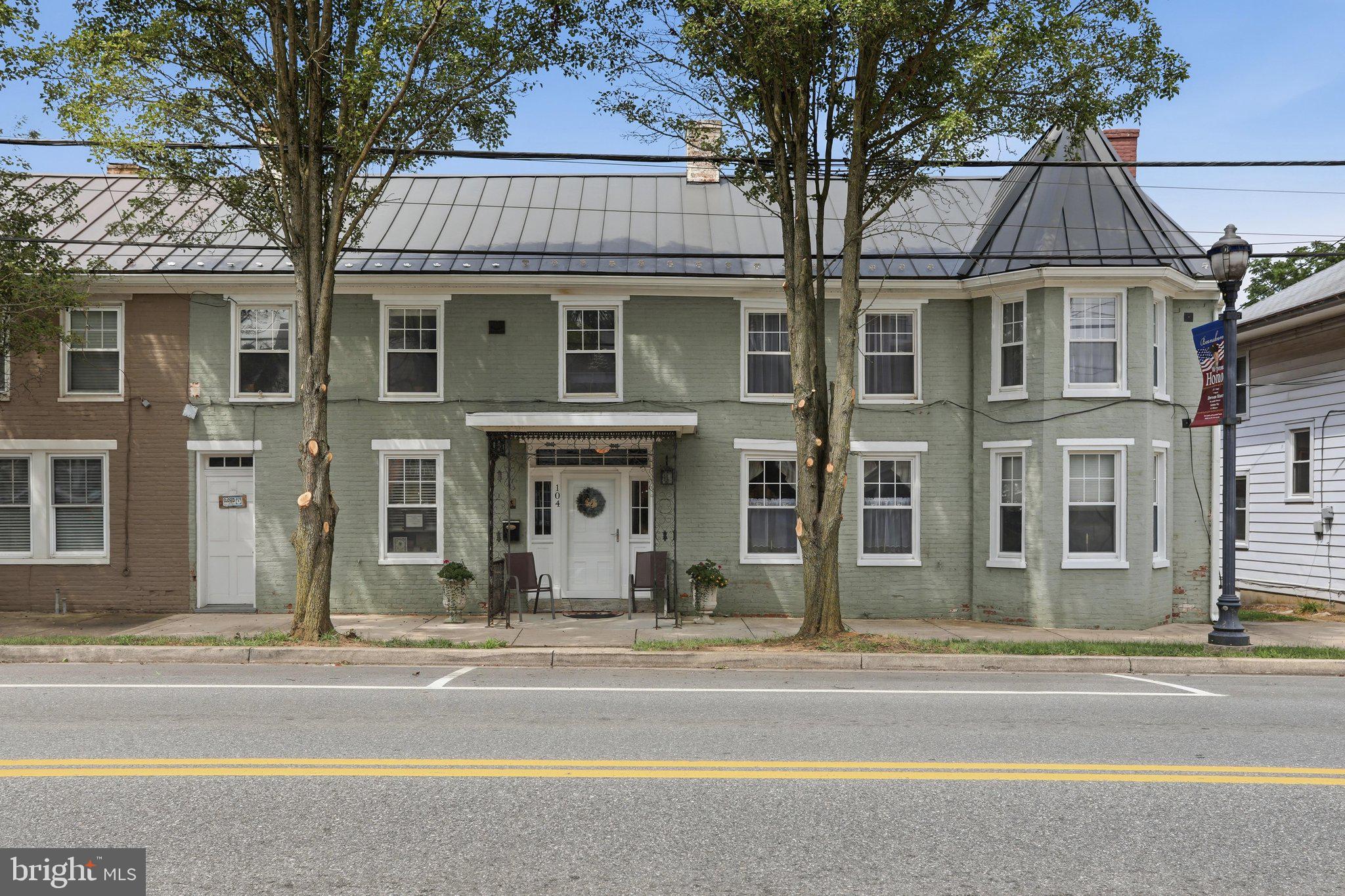 Step back into history with this beautifully maintained all-brick circa 1900   historic home located in the heart of the Boonsboro Historic District. This spacious Main Street property offers over 3,700 square feet while blending historic charm with a prime location along the former National Road. Just minutes from South Mountain, Antietam, local shops, restaurants, and parks, this home is part of one of Washington County's most treasured historic communities.
Boasting five bedrooms and four baths, and a first-floor Town Center commercial space with its own storefront entrance. Gorgeous original hardwood flooring throughout.  Formal living room w/ fireplace.  Formal dining room.  Impressively sized kitchen with a center island.  A walk-in pantry with additional pantry cabinetry.  Potential space for a main-level bedroom.   Upper-level laundry area.  This unique property offers endless possibilities for investment, Bed and Breakfast, Airbnb, or other mixed-use opportunities. The spacious backyard includes a buildable lot and backs to a peaceful town park. Modern updates include a steel roof (2017), central HVAC, updated windows, new deck stairs and banisters (2026), upgraded electrical, city water and sewer, plus a private well. Rear driveway parking adds extra convenience. Own a timeless piece of Boonsboro history with the perfect blend of historic character and modern updates.  Walking distance to restaurants and boutique shops.  Minutes to Interstate 70 and Route 67 leading to Route 340 and the West Virginia line.