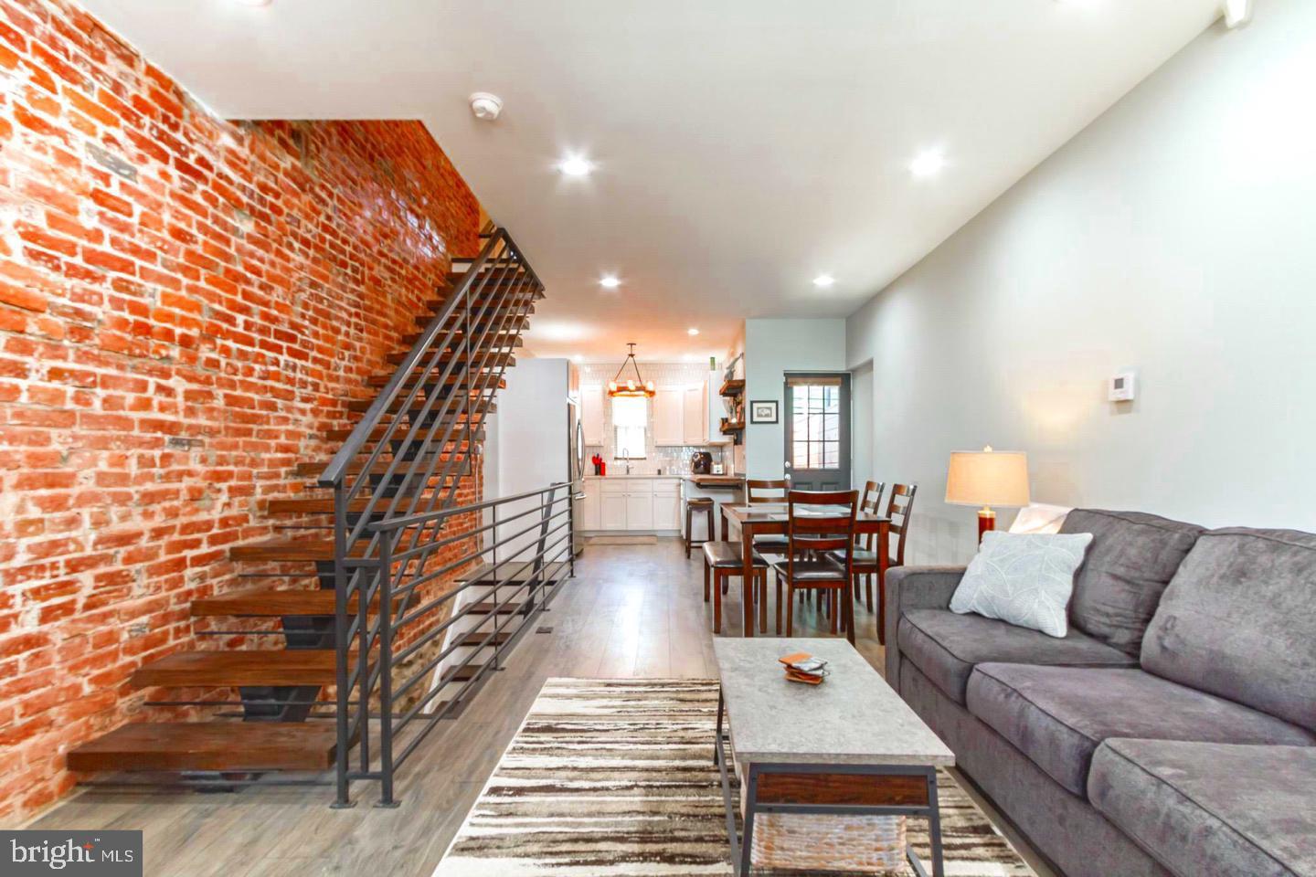 Nestled in the charming Grays Ferry neighborhood, this beautifully renovated interior row townhouse offers a perfect blend of modern luxury and classic charm. Originally built in 1925, this home underwent a major renovation in 2020, transforming it into a sophisticated retreat that exudes warmth and comfort. Step inside to discover an inviting open floor plan that seamlessly connects the living, dining, and kitchen areas, creating an ideal space for both relaxation and entertaining. The luxury vinyl plank flooring flows throughout, providing a stylish yet durable foundation that complements the home's elegant aesthetic. The heart of the home is undoubtedly the gourmet kitchen, equipped with high-end stainless steel appliances, including a gas oven/range, refrigerator, microwave, dishwasher, and convenient washer and dryer. Whether you're preparing a casual meal or hosting a dinner party, this kitchen is designed to inspire culinary creativity while offering ample storage and counter space. With two spacious bedrooms and two full bathrooms, this residence provides a comfortable sanctuary for rest and rejuvenation. Each bathroom has been thoughtfully designed with modern fixtures and finishes, ensuring a spa-like experience at home. The layout maximizes natural light, creating a bright and airy atmosphere that enhances the overall sense of tranquility. The full basement offers additional potential for customization, whether you envision a cozy den, a home gym, or extra storage space. Outside, the property features a low-maintenance lot, allowing you to spend more time enjoying the vibrant community and less time on upkeep. Parking is convenient with on-street options available, making it easy to come and go as you please. The Grays Ferry neighborhood is known for its friendly atmosphere and proximity to local parks, shops, and dining, providing an exclusive lifestyle that balances urban convenience with a sense of community. This home is not just a place to live; it's a lifestyle choice that embraces modern living while honoring its historical roots. Experience the perfect blend of luxury, comfort, and community in this stunning Grays Ferry townhouse. Your dream home awaits!