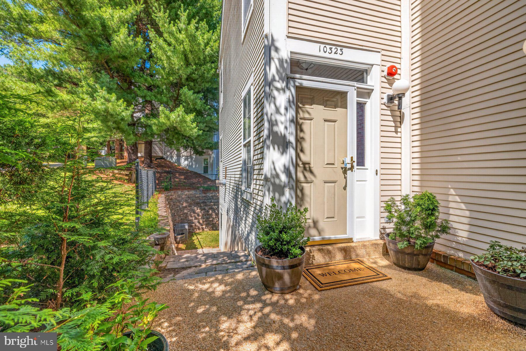 Welcome to this rarely available, original-owner end-unit townhouse offering a traditional floor plan, abundant natural light, a one-car garage and private driveway parking. The desirable end-unit location also provides additional rear access to the fully finished level walk-out basement. The finished lower level includes a legal bedroom, full bath, secondary laundry area, and a spacious recreation area, making it ideal for guests, multi-generational living, a home office or potential rental use. The main level showcases hardwood floors, a bright and spacious living room with a cozy gas fireplace and sliding glass doors leading out to the deck. The kitchen offers granite countertops, stainless steel appliances (less than one year old), space for casual dining and opens to a separate dining area. A convenient main-level laundry room and an updated hall bath featuring a porcelain tile floor and matching wainscoting. Upstairs you'll find three bedrooms, including a generously sized primary suite with two closets and an updated en-suite bath featuring a tiled shower and frameless sliding glass doors. Major systems have been updated, including a roof replaced less than seven years ago, along with a three-year-old HVAC system and water heater. Enjoy peace of mind knowing you can focus more on enjoying the home and less on major projects. Ideally located close to shopping, restaurants, public transportation and major commuter routes. Schedule your tour today!