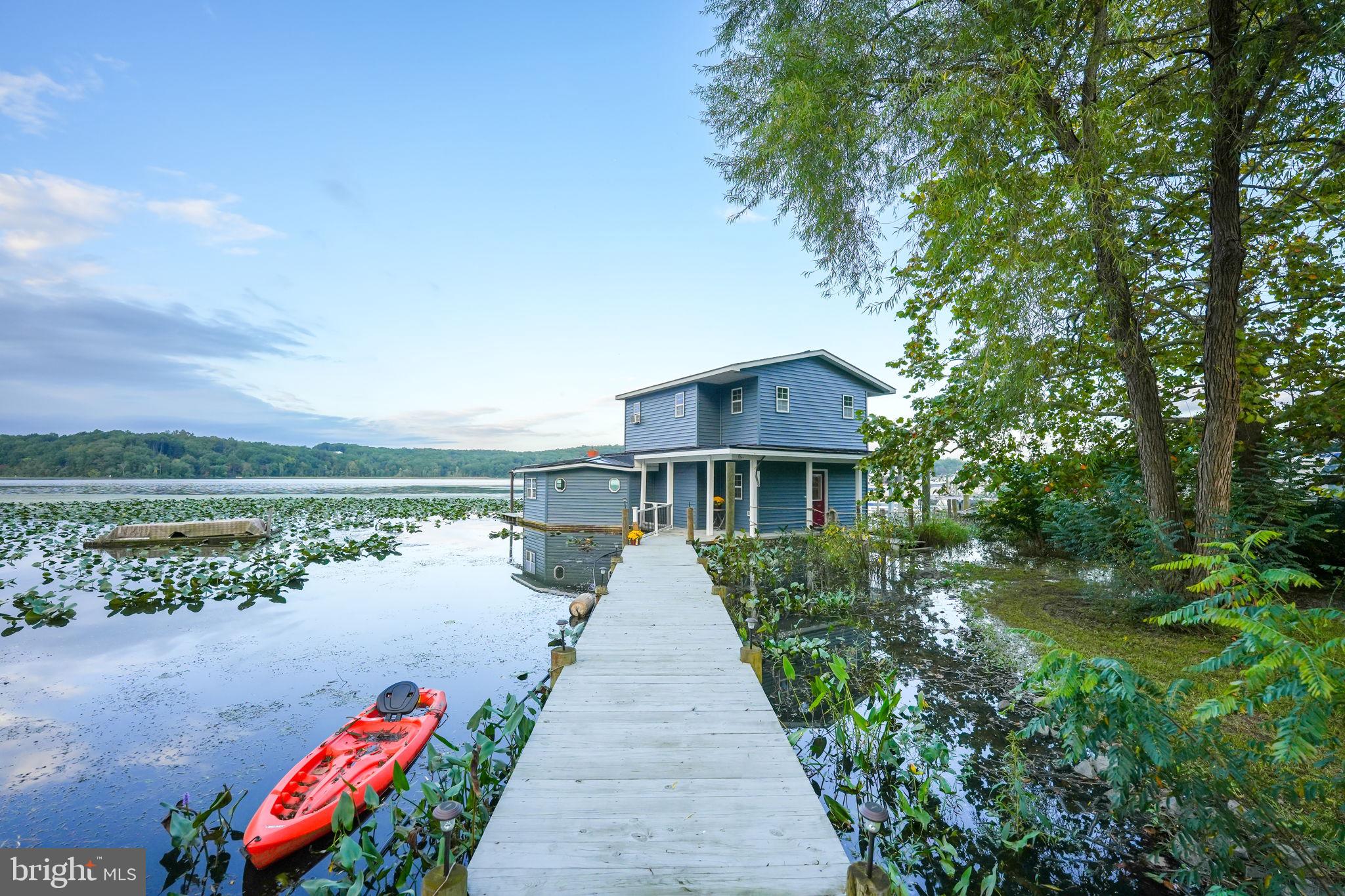 YES, IT'S REAL!!!! CONVERTED CUSTOM FLOATING HOME WITH NO TAXES!!!!! CONNECTED TO LAND WITH DOCK, 2 CAR GARAGE, SHED BUILDING WITH BAR, HOT TUB, SWIMMING POOL AND ENTERTAINING PARADISE ON AQUIA CREEK NEXT TO MARINA AND JUST MINUTES DOWN TO THE POTOMAC RIVER WITH GREAT SHELTER***2 CAR GARAGE FRAMED OUT FOR APARTMENT AND/TONS OF STORAGE****ONE OF THE MOST UNIQUE PROPERTIES YOU CAN IMAGINE!!!! SUPER PRIMARY SUITE ON UPPER LEVEL SO YOU WAKE UP EVERY MORNING LOOKING ACROSS THE WATER!!! A MUST SEE!!!