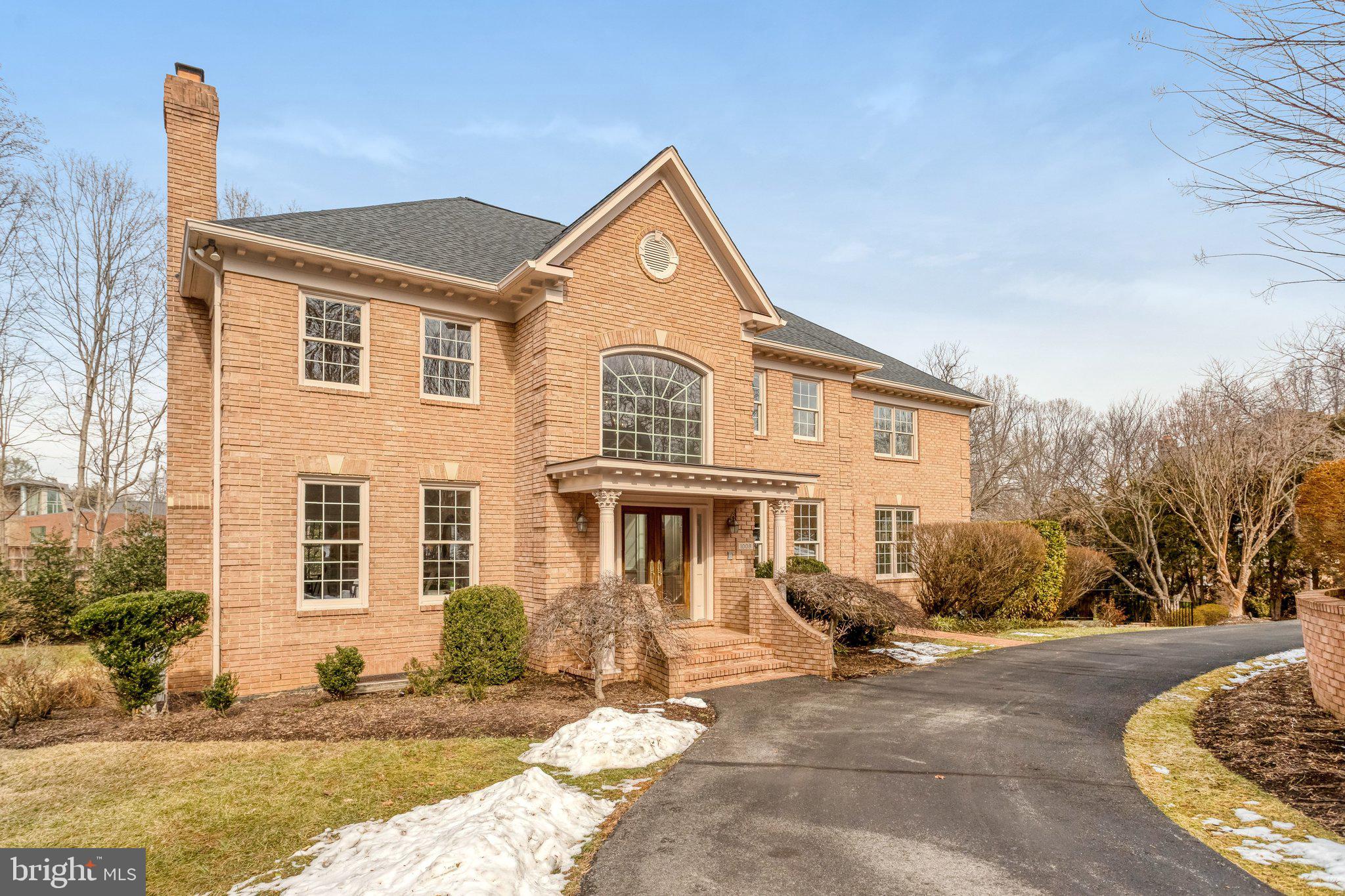Nestled on a quiet cul de sac in one of McLean’s most desirable neighborhoods, this exceptional four sided brick Colonial offers timeless architecture, refined upgrades, and 6183 total square feet of designed living space. Sited on just under an acre of landscaped grounds, this 6 bedroom, 5.5 bath residence blends elegance and functionality, with gracious proportions, abundant natural light, and sophisticated finishes throughout. A circular driveway and oversized three car side load garage enhance both curb appeal and everyday convenience.
 
The main level is thoughtfully designed for both entertaining and comfortable living, featuring formal living and dining rooms with a classic butler’s pantry, a private library or home office, a guest suite with full bath, and an inviting family room anchored by a striking floor to ceiling stone fireplace. The gourmet kitchen serves as the heart of the home, complete with a large center island, updated appliances, Wolf range, warming oven, Sub-Zero oversized refrigerator & freezer, Fisher & Paykel dishwasher and a bright breakfast room opening to the spacious deck and beautifully maintained rear grounds. Fresh interior paint and new carpeting in 2025 complement custom built ins, oversized windows, and multiple fireplaces, creating warm, yet refined living spaces.
 
Upstairs, the luxurious primary suite offers a true retreat with a gas fireplace, private balcony, wet bar, dual walk in closets, and a spa inspired bath featuring double vanities, soaking tub, steam shower, and separate water closet. Three additional bedrooms and well-appointed baths complete the upper level. The walk out lower level provides exceptional flexibility with a large recreation room, second kitchen with breakfast area, additional bedroom and full bath, ideal for guests, extended family, or entertaining.
 
Extensive capital improvements provide lasting peace of mind, including a roof replacement in 2026 with transferable warranty, HVAC updates, water heater replacement, refinished garage floor, new attic exhaust fan, refreshed landscaping, and additional recent enhancements. Located within the Langley School Pyramid (steps away) and just minutes to Washington, DC, Tysons, Metro access, and major commuter routes, this remarkable property offers privacy, convenience, and enduring value in the heart of McLean.