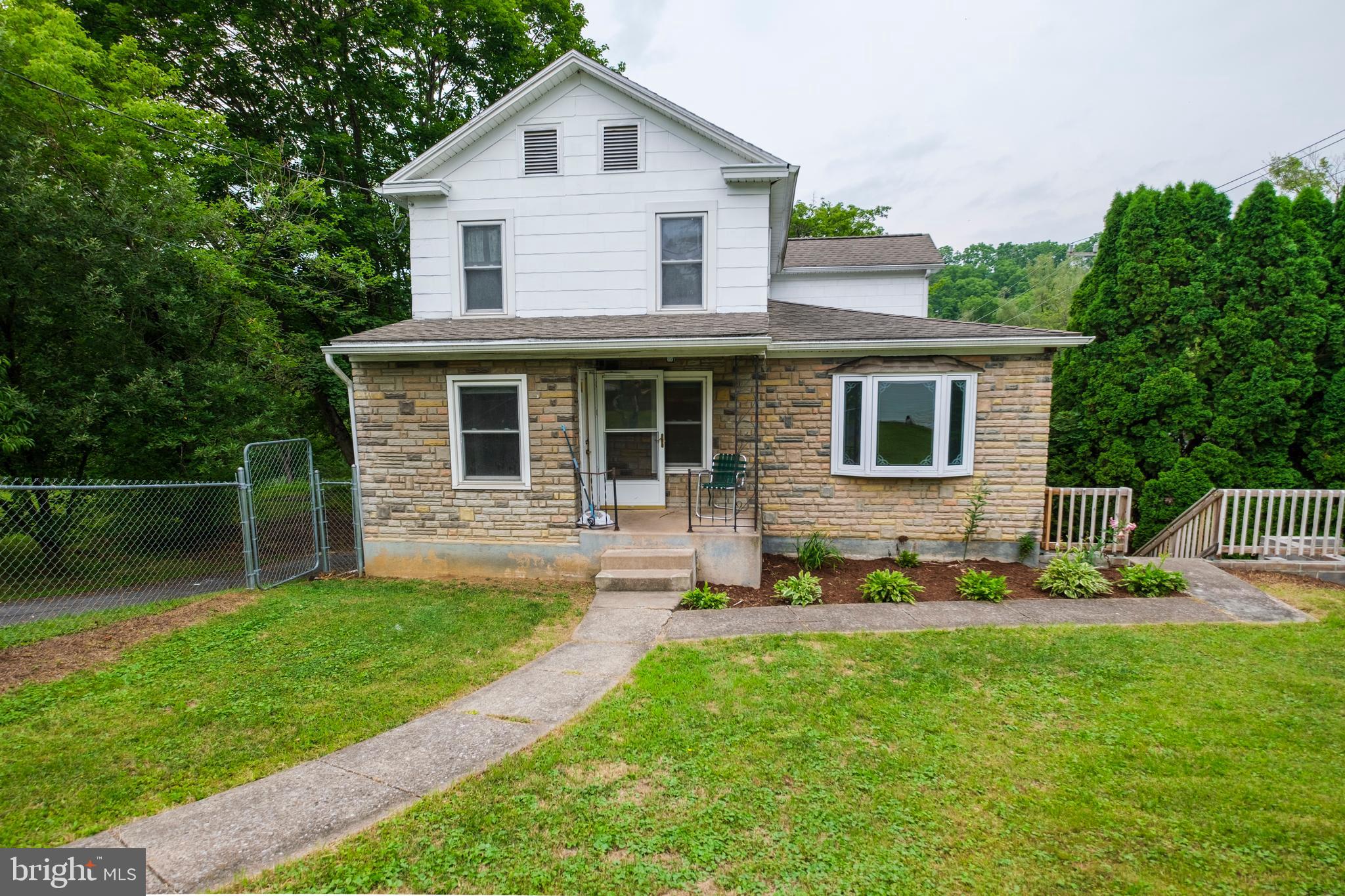 Imagine having 117 feet of frontage along renowned Spring Creek, where world-class trout fishing begins just steps from your backyard. Perfectly positioned on a scenic .44-acre lot in Busch Addition, this inviting home offers the perfect blend of peaceful living & everyday convenience. Located just moments from historic downtown Bellefonte, with an easy commute to the State College Regional Airport & Penn State University, you'll enjoy a location that places shopping, dining, recreation & community events all within easy reach.  A welcoming covered front stoop creates a warm first impression, while plenty of off-street parking, a detached garage, shed & a fenced yard provide the space & functionality today's homeowners appreciate.  Step inside to discover a spacious living room with laminate flooring, stone accent wall & a bay window, separate formal dining room & a generously sized eat-in kitchen designed for everyday living & comes complete with luxury vinyl plank flooring, tile backsplash, included appliances & a pantry. Charming exposed beams & a greenhouse garden window above the kitchen sink fills the space with natural light, creating the perfect spot for herbs, houseplants, or simply enjoying the view while preparing meals. A first-floor bedroom features hardwood flooring, 2 closets & has access to the full bathroom.  A handy laundry/mudroom room with an exterior entrance offers added flexibility & allows convenient single-level living a possibility.  Upstairs, you'll find 2 additional bedrooms, a second full bathroom with LVP flooring & a versatile bonus room currently used as a walk-in closet & is ready to adapt to your changing needs. Whether you envision a home office, reading nook, or the potential to create an additional bathroom, this flexible space offers endless possibilities.  The full unfinished walk-out basement provides abundant storage & room to grow, offering plenty of space for hobbies, a workshop, or future finishing opportunities.  The backyard is where this property truly shines. The rear patio overlooks the private, tree-lined yard as it gently extends to Spring Creek frontage, creating an extraordinary outdoor retreat. Whether you're casting a fly line into one of Pennsylvania's most celebrated trout streams, relaxing to the peaceful sounds of the flowing water, or enjoying your morning coffee surrounded by nature, this remarkable setting offers a lifestyle that few properties can match.  Offering the perfect balance of small-town charm, outdoor recreation & everyday convenience, this exceptional property invites you to experience everything that makes Bellefonte such a special place to call home. Spend your afternoons exploring the boutiques, restaurants, parks & rich history of downtown before returning home to unwind beside the creek. More than just a place to live, this is a rare opportunity to enjoy the beauty of nature, the convenience of town & the unforgettable lifestyle that comes with owning a home along Spring Creek.