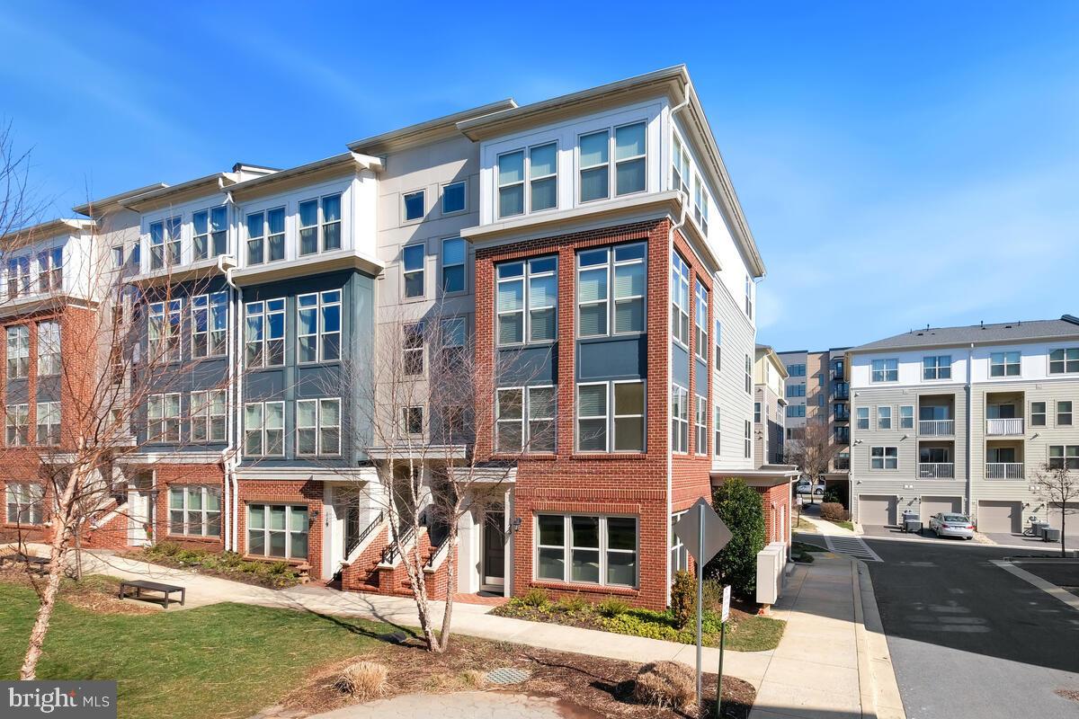 Welcome to the epitome of refined living at 123 Copley Circle, nestled in the vibrant heart of Gaithersburg's coveted Crown community. This luminous end-unit townhome-style condo boasts three bedrooms, 2.5 baths, and a generously proportioned 1,707 Sq Ft of luxury. Step inside to discover captivating hardwood floors that flow seamlessly throughout the expansive open floor plan, accented by lofty ceilings adorned with tasteful crown molding. The chef's kitchen, equipped with stainless steel appliances and a 5-range gas stove, invites culinary creativity, while the living room fireplace adds warmth and charm. Natural light floods the primary bedroom through eight windows; each tastefully outfitted with luxury blinds for privacy and style. The primary bathroom features a double vanity, a standing shower, and a tub for relaxation. The second bedroom offers a cozy retreat with ample closet space, while the third bedroom opens to a balcony, creating an ideal spot to unwind and enjoy the surroundings. Ideally situated in the Crown community, with close proximity to the Rio and Kentlands, this property provides easy access to an array of dining, shopping, and entertainment options. Effortless commuting is assured with nearby access to commuter routes 1-270, I-370, 200 (ICC), and the Shady Grove Metro station.