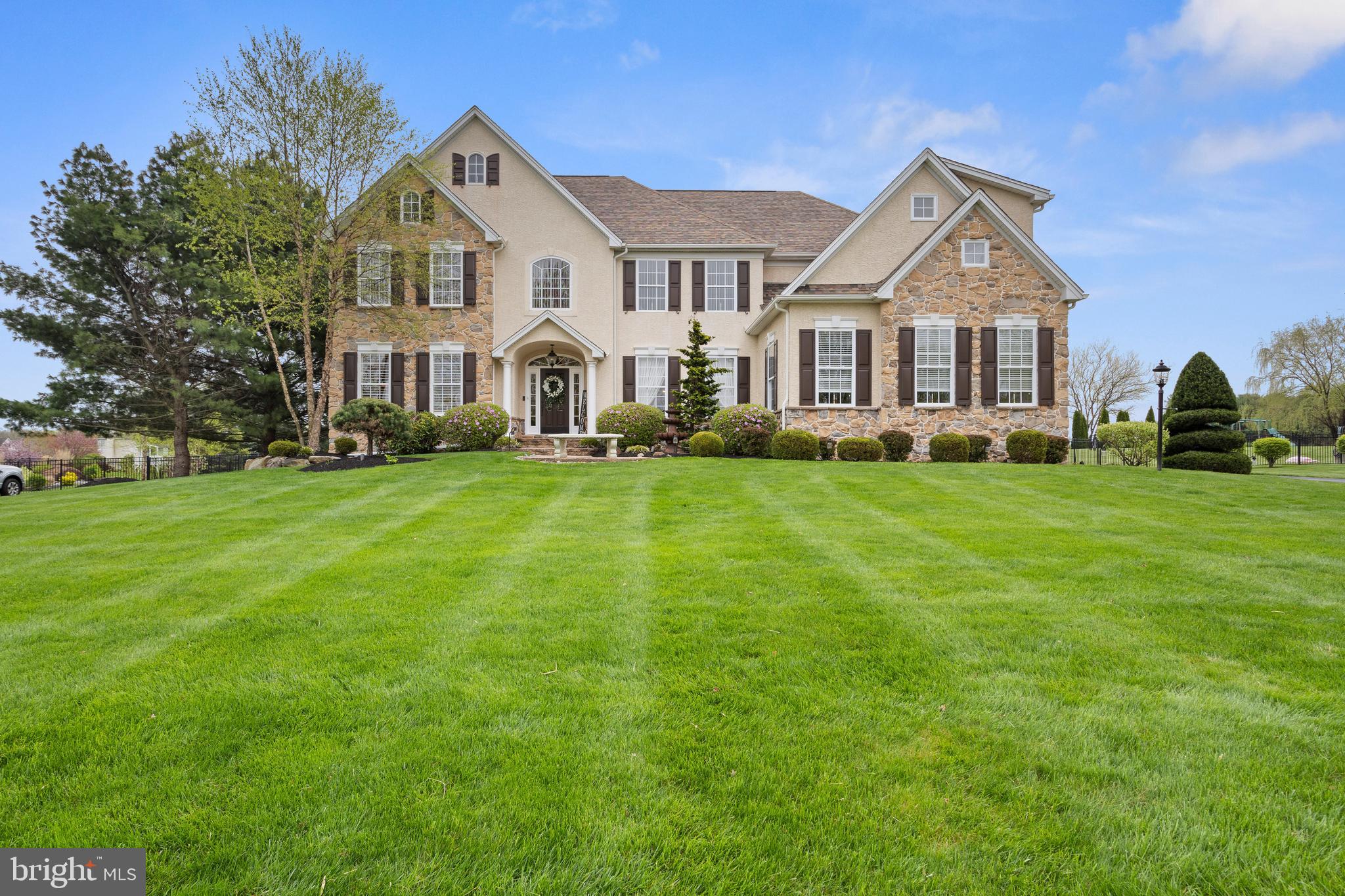 Welcome home to 3234 Hamilton Lane! Located in the prestigious Greystone Community in the Garnet Valley School District, this stunningly updated, meticulously kept 6 bedroom, 4.5 bath home boasts many options for entertaining as well as private spaces to unwind and enjoy. In addition to a traditional living and dining room on the first floor, the kitchen-where everyone seems to congregate-opens into a family room with gas fireplace and large eat-in area, both with cathedral ceilings. A beautiful foyer, powder room, mudroom, pantry, and large office complete this level. There are hardwoods, custom trim and window treatments, new paint, crown molding, and modern black plumbing fixtures accenting the first floor. Accessible from both the hall and the kitchen area, the covered porch provides a comfortable retreat overlooking the manicured lawn with sprinkler system, outdoor fireplace with seating area, hot tub, and inviting heated pool. Accessible by two staircases, the second floor features five bedrooms, including the primary bedroom with en suite bath, double vanities and closets plus four additional bedrooms which share two full baths, and conveniently located upper floor laundry room. Descend to the newly painted finished lower level featuring the tasteful and well-appointed 8 seat granite bar, with everything you need for a large party or an intimate gathering: bar fridge, wine fridge, ice maker, sink, microwave, and convenient dishwasher. A bedroom and full bath along with a seating area with gas fireplace make this a perfect getaway for a guest or someone preferring their own space.  There is room for a pool table and a game area, as well as ample storage and a theater sound system. If you require more storage, use the stand-up attic or shed out back! Please review the many inclusions and updates listed in the documents regarding the listing, as there are simply too many to list here. This is one of Delaware County’s most desirable neighborhoods and absolutely one of Garnet Valley’s finest! Come see this one ASAP!