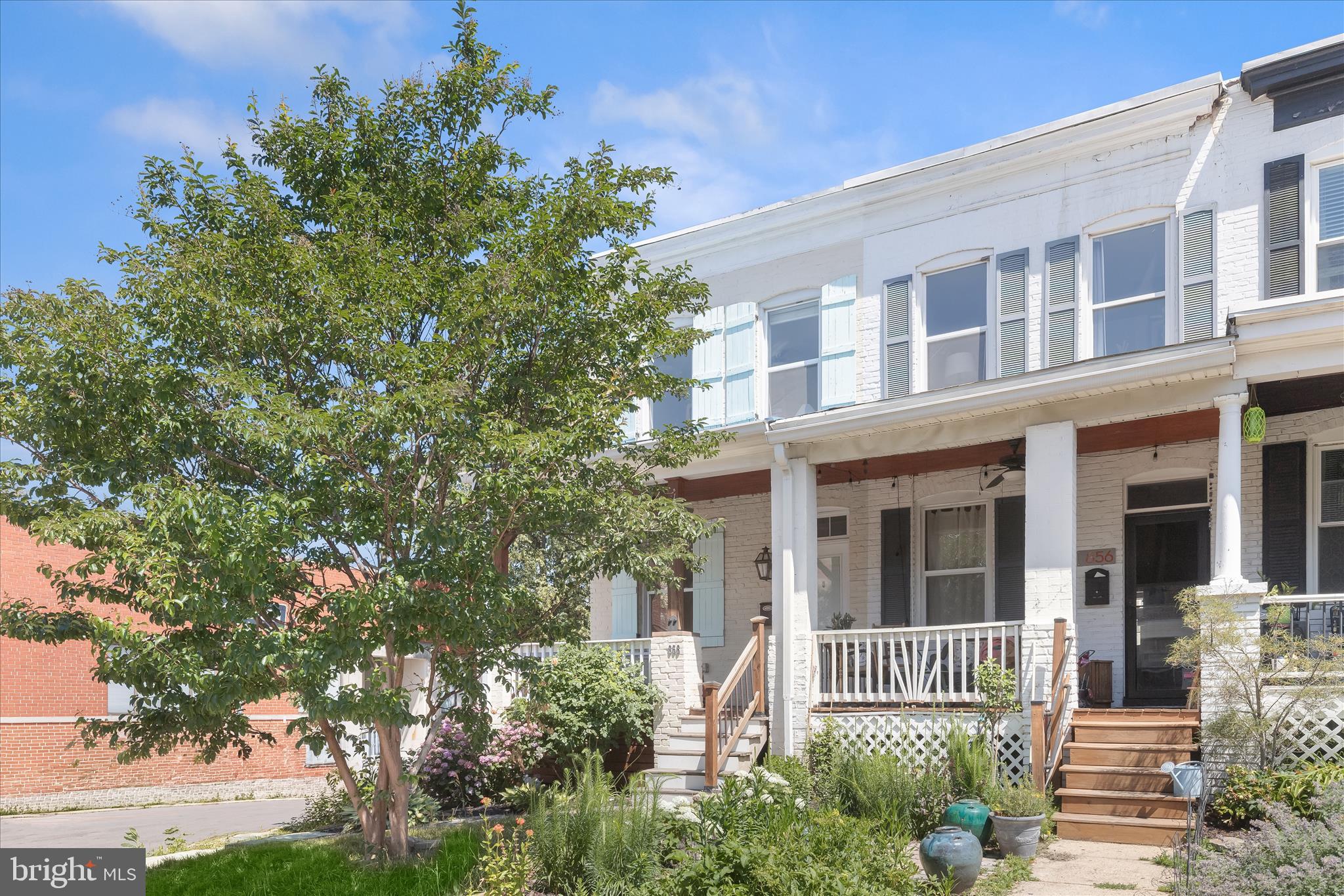 Introducing this three bedroom, one-and-a-half bathroom end-unit rowhome nestled in the charming Hampden neighborhood. You will love exploring all the local shops, dining, entertainment options, parks and small businesses just moments away. As you arrive, a covered front porch creates a welcoming first impression and provides a relaxing outdoor space. Inside, the home has been freshly painted throughout with a neutral color, complemented by an abundance of natural light. The open-concept main level showcases rich hardwood floors, with a front living room and a separate dining room. The kitchen is equipped with stainless steel appliances, an island with seating, recessed lighting and access out back. A half bathroom finishes the main level. Upstairs includes three bedrooms, each with plush carpeting, and a full bathroom with a tub-shower. Downstairs, the lower level adds versatile living space with a flexible recreation room that has access outside. A utility room includes laundry and ample storage space. Outside, there is a deck off the kitchen and a rear patio that is fully-fenced. Just around the corner from Roland Avenue, Falls Road and I-83, this home offers both charm and convenience in one of Baltimore’s most sought-after neighborhoods.