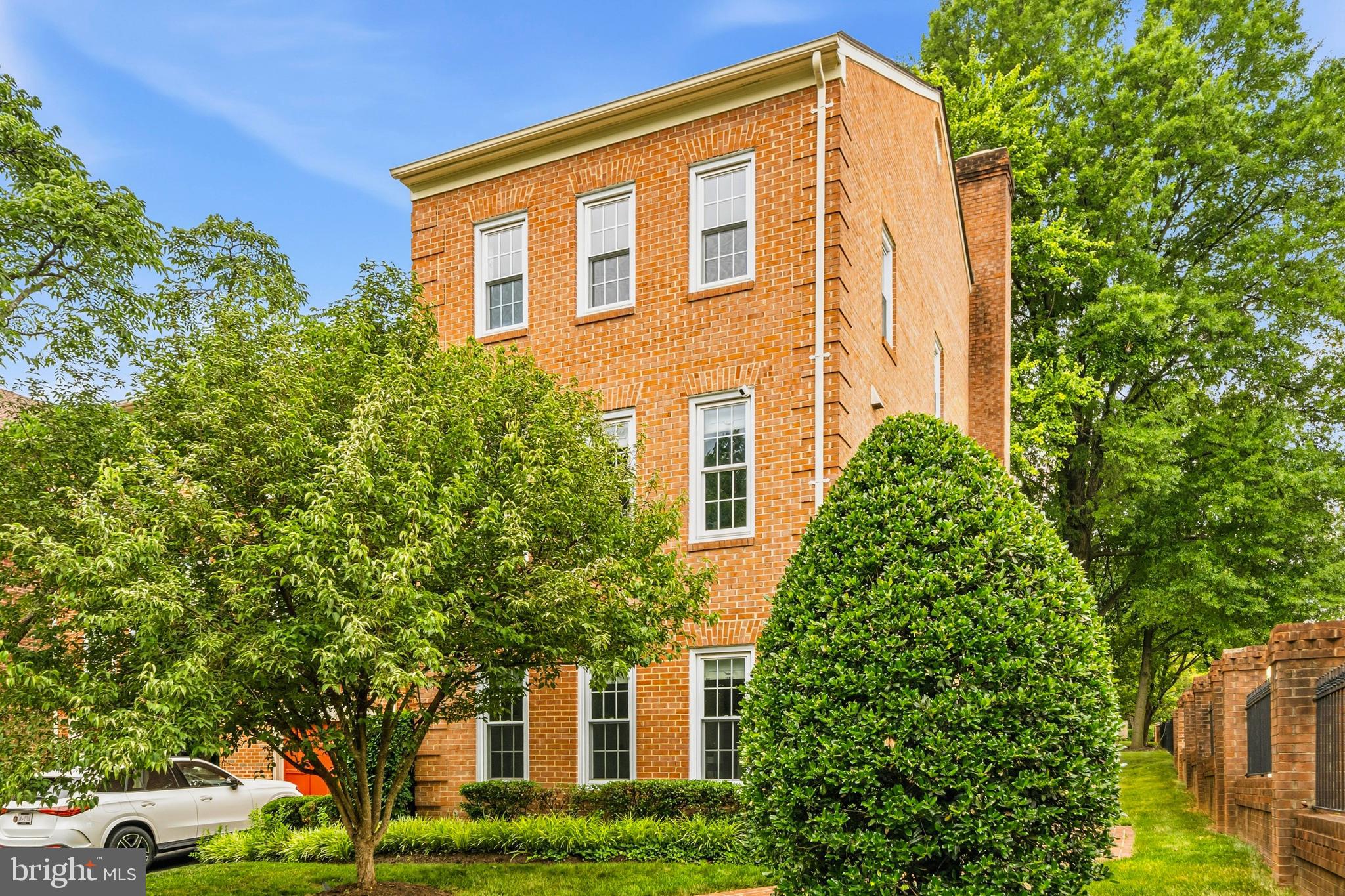 This spacious and sun‑lit townhome‑condo offers a peaceful retreat in South Arlington with thoughtful updates and inviting indoor‑outdoor living. Enter through the lower‑level foyer to find a bright home office or third bedroom, an updated half bath, a welcoming family room with a wood-burning fireplace, and walk‑out access to a lovely brick patio featuring a brick‑walled Japanese maple and serene views of community green space. Newly added LVP flooring with 5.25‑inch baseboards enhances this level, along with convenient storage spaces. Upstairs, the main level feels open and airy with a beautifully renovated kitchen featuring Quartzite countertops, a Café microwave and double‑oven range, a beverage fridge, a large island, and a hidden laundry and utility room tucked behind custom cabinetry. The kitchen flows seamlessly into the dining and living rooms, highlighted by crown molding and abundant natural light. The upper level offers two oversized bedroom suites with renovated bathrooms, plus pull‑down attic access with an insulated zipper cover and blown‑in insulation added in 2020. Hardwood flooring spans the two upper levels, refinished in 2020. Additional features include two assigned parking spaces, nearby street parking, a 2024 air condenser and gas HVAC, a 2024 Rheem water heater, and smart home upgrades including a Ring doorbell, Ring security system, and August smart lock. Peaceful, bright, and move‑in ready, this home blends comfort, style, and convenience in a prime Arlington location. Convenient to Rt 50, Seven Corners (0.7 mi), Bailey's Crossroads (1.6 mi),  Ballston Quarter (1.7 mi), East Falls Church Metro (2.3 mi), Ballston Metro (2.3 mi), Shirlington (4.1 mi), the Pentagon (4.5 mi), and Reagan-National Airport (DCA, 6.2 mi).