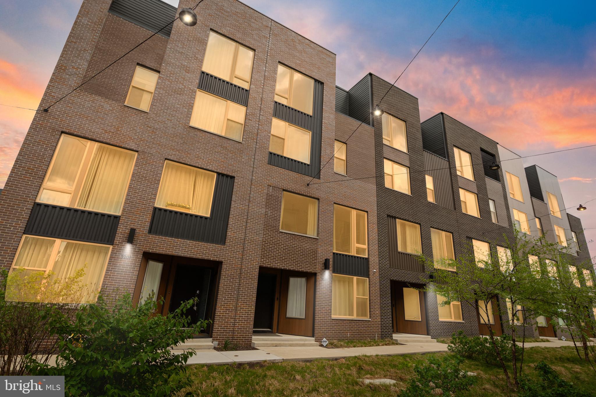Welcome to 3203 Sunrise Walk, a stunning waterfront, move-in-ready four-bedroom home located in the desirable Fishtown neighborhood. Built in 2021, this modern, four-story rowhome offers luxury designer finishes and modern conveniences, including a 2-car garage, private elevator, and security system. Enjoy peaceful living near the water in this exceptional property. 

The lower level provides convenient access to the garage and includes a fantastic bonus space currently used as a home gym, a half bath, and ample additional storage. Flowing wood floors unify the open-concept main living level, which encompasses the kitchen, living room, and dining room. The kitchen is an entertainer's dream, featuring a full suite of stainless steel appliances, a range hood, and a functional island with excellent storage. A modern chandelier illuminates the dining space, which is further elevated by gorgeous accent wallpaper. For added convenience, a second half bath is located just off the dining room. Two oversized windows brighten the main living room, which is stylishly upgraded with a faux-wood-panel accent wall. The second floor offers three sunny and spacious bedrooms, each featuring generous storage with walk-in closets. One bedroom includes an ensuite bathroom, and a full bathroom is conveniently located in the hallway. A dedicated laundry room completes this level. The top floor features a primary retreat with a large walk-in closet and a luxurious ensuite. This private bath includes a double sink vanity, a separate walk-in tiled shower, and a standing soaking tub. This home has two outdoor spaces, one deck on the fourth floor, and the expansive roof deck offering relaxation and city views with the Ben Franklin Bridge. Enjoy a 10-year tax abatement with 6 years left!

Experience unparalleled convenience and commuter-friendly living in this dynamic neighborhood. Located a 6-minute walk from the nearest light rail station, this development offers easy access to the Delaware Expressway and Fishtown Crossing. Residents benefit from world-class dining, boutique shopping, and direct access to a neighborhood walking path.