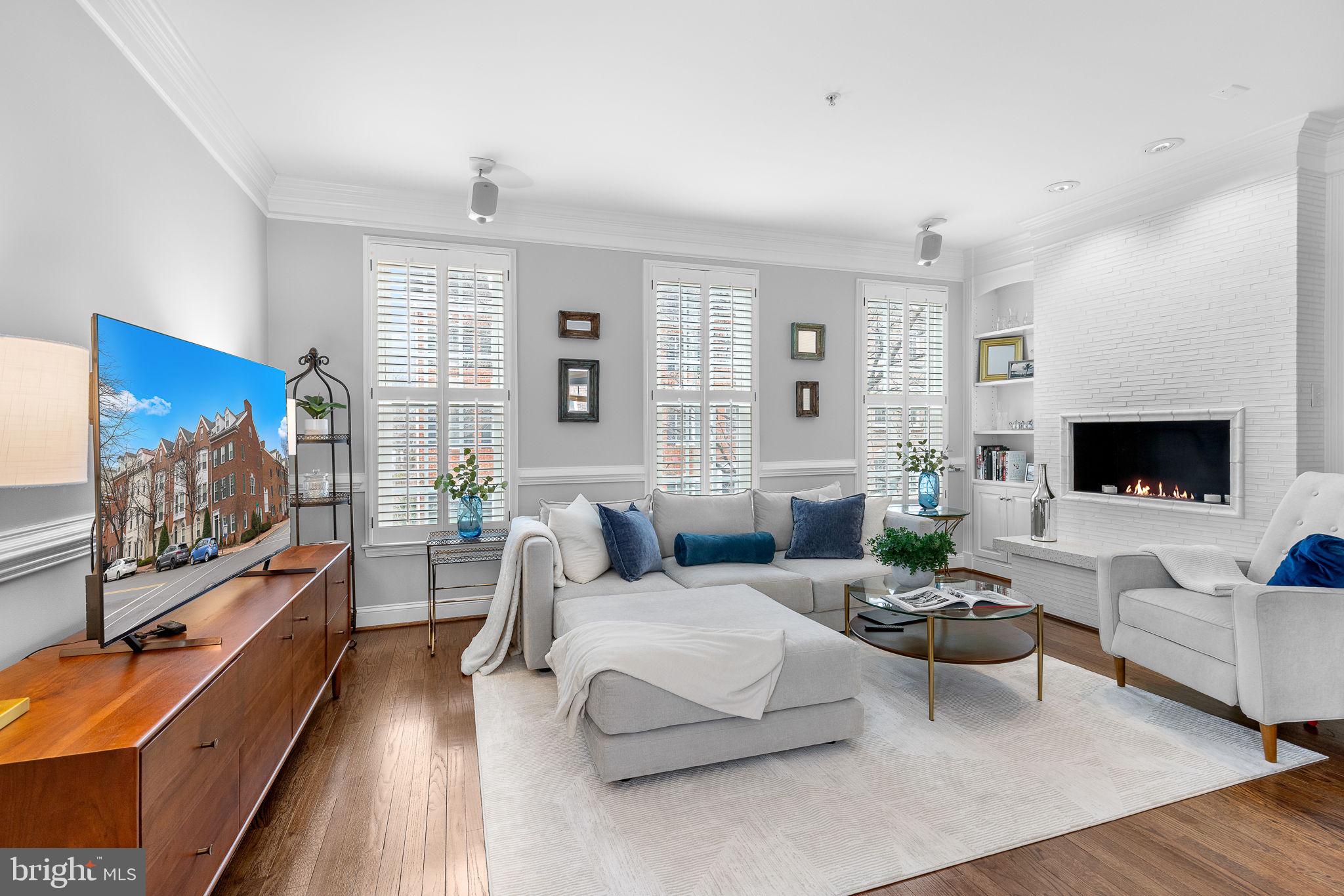 Old Town Alexandria — Timeless Charm, Modern Convenience, Unbeatable Location!

Just three blocks to the waterfront, this stunning 4-level end-unit townhome offers the perfect blend of historic charm and contemporary updates. With 3 bedrooms + den, 3.5 baths, and a private 2-car garage, this home is a rare find in Old Town!

Step inside to discover rich oak hardwood floors, custom plantation shutters, and exquisite designer tile throughout. The flexible entry-level den/office is perfect for working from home, while the attached garage with a 220V EV charger makes city living effortless.

The main level features an elegant, light-filled living and dining space with crown molding, a ventless fireplace flanked by built-ins, and double French doors leading to the gourmet kitchen. Featuring Mouser cabinetry, a heat- and stain-resistant Dekton island, stainless steel appliances, and a sunny bay window, the bright white kitchen opens to a Trex-style deck.

On the upper level, you’ll find two spacious bedrooms with walk-in closets and gorgeous spa-inspired baths. The luxurious primary suite boasts a bay window and heated floors in the ensuite bathroom. The top floor is a flexible retreat — the large bedroom can double as a media room, guest suite, or additional living space — complete with vaulted ceilings, recessed lighting, and a full bath!

Location is everything! Just blocks to Alexandria’s bustling King Street, the growing Oak district, and the scenic waterfront with its amazing mix of shops, restaurants, and cafes. Offering easy access to King Street Metro, Reagan National Airport, and major commuter routes (GW Parkway, I-495, and I-95), this elegant townhome is ideal for those seeking both convenience and the vibrant Old Town lifestyle.

Don’t miss out on this rare opportunity! Schedule your private tour today and see why this home is a standout in Old Town.