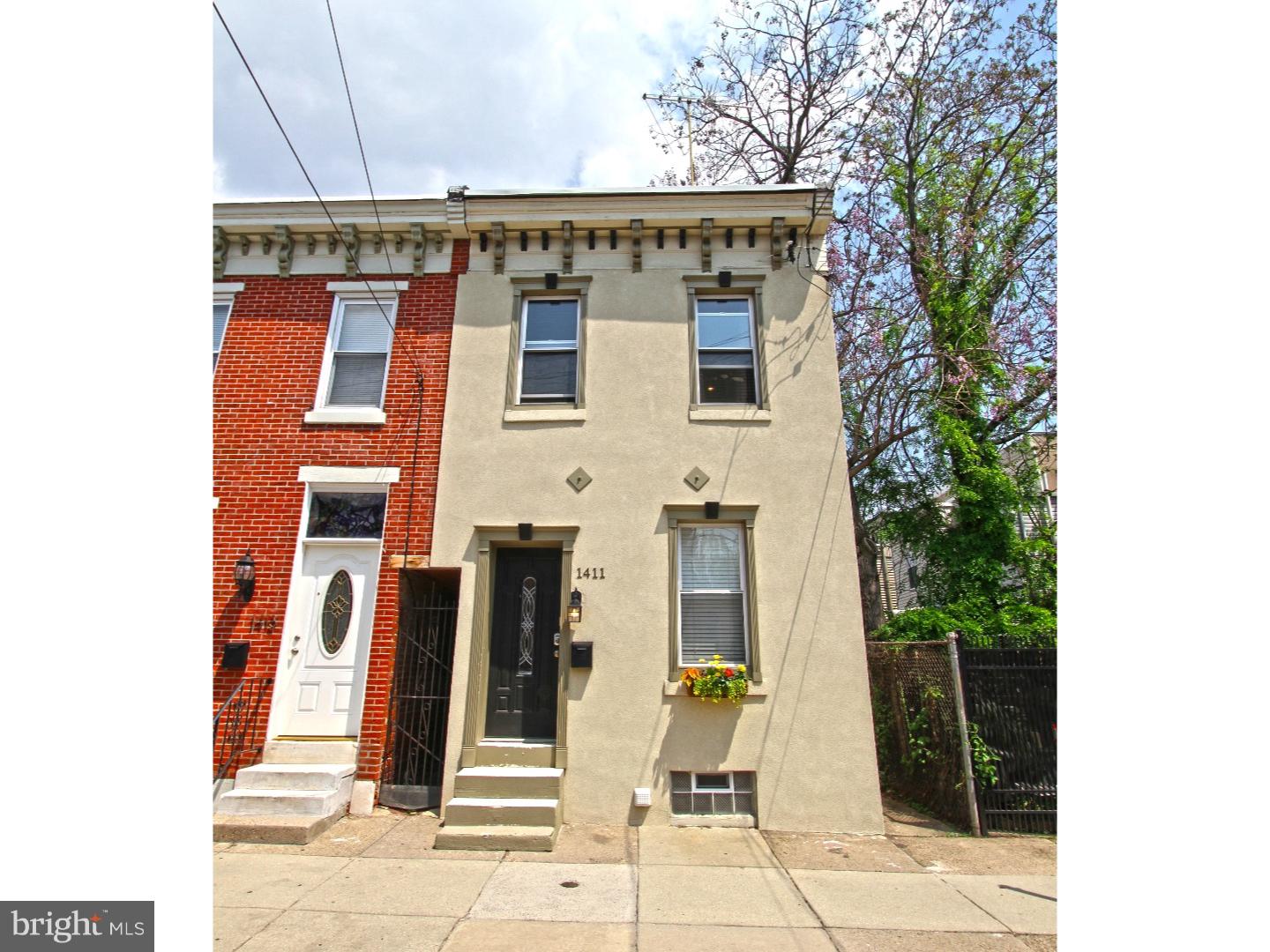Charming and spacious 2 bedroom, 1 bath, beautiful fenced in yard in the heart of Fishtown. Notice the original decorative cornice on this end unit 2 story row home. Enter in to a formal living room and open layout with center dining area. Bamboo flooring throughout the entire 1st floor. The kitchen is completely fitted out with stainless appliances, gas range, glass tile back splash, polished granite counters, solid wood cabinetry, and there is a bonus beverage nook with granite counter top, a large wine refrigerator, wine rack and extra storage. This built in can double as a server when entertaining. Speaking of entertaining, we love the enclosed back yard with an area for plantings, a deck space for seating and plenty of room for a grill. The fences opens to 2 sides of the yard making recyclables and refuse storage a breeze and out of site. The home has central air and heat and the condenser is tucked away over the shed roof allowing the yard to be completely unobstructed. Back inside the custom iron hand rail will lead you up the staircase to the 2nd floor. Both the master and guest room are very large with a lot of closet space. There is a center hall bath that you must see. It has custom linen textured ceramic tiles, a soft pebble stone floor, large storage vanity and dual shower heads in the shower of which one is a magnificent rain fall design. The laundry room is on this level as well with a side by side front load washer and dryer and linen storage shelves above. Need more storage? Then you are in luck! The basement is big and open and full size unfinished offering ample space for all of your belongings. What a fantastic home! We welcome your visit.