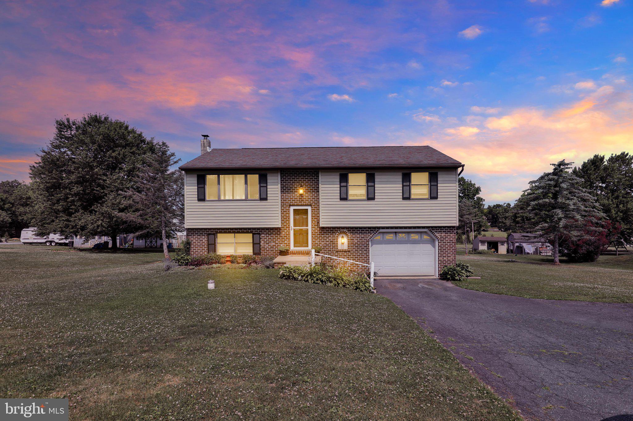 Welcome to 220 Pleasant Valley Rd in East Earl, a beautifully presented single-family bi-level home set in Lancaster County’s Brecknock Township and located within the Eastern Lancaster County School District, serving Garden Spot High School. This home offers a wonderful blend of comfort, functionality, and indoor-outdoor living, with 3 private bedrooms, multiple living spaces, and a layout designed to make everyday living easy.

The main level features a bright and inviting living area with large windows, neutral finishes, and attractive flooring that flows nicely into the dining and kitchen space. Off the kitchen, sliding glass doors lead to the second-floor deck overlooking the spacious, flat rear yard. Whether enjoying a quiet morning, grilling, entertaining, or simply taking in the backyard views, this outdoor space adds tremendous value to the home.

The finished lower level expands the living space even further and offers incredible flexibility for a second living room, recreation area, home office, workout space, media room, or guest area. A wood-burning stove adds warmth and character, creating a comfortable gathering space during the colder months. The lower level also features sliding glass doors that open directly to the rear patio and backyard, giving the home a seamless connection to the outdoors from both levels.

Another standout feature is the potential to add an additional bathroom in the lower level, with plumbing already set up, offering future convenience and added value. The attached 1-car garage provides direct access to the finished lower level, making storage, parking, and daily use even more practical.

With a spacious yard, rear deck, patio, finished lower level, wood-burning stove, attached garage, and thoughtful bi-level layout, this home offers more than just a place to live. It offers space to relax, gather, entertain, and grow. A fantastic opportunity in a desirable Lancaster County setting.

This home will not last long. Schedule a showing today!
