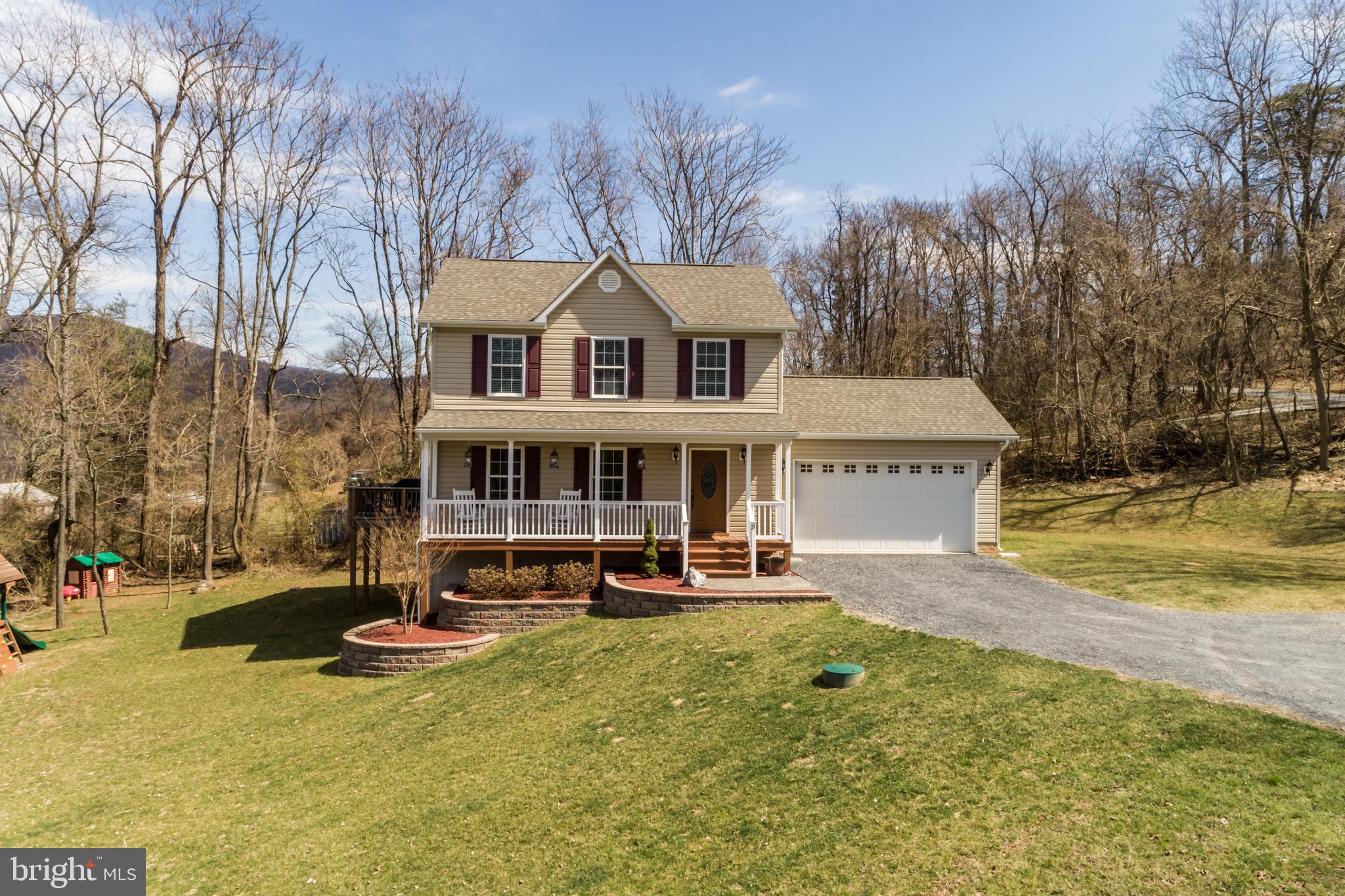 Welcome to Lake Front Royal! This 3 year young, well maintained home is located on a corner lot just a short distance to state maintained road and just minutes to town. The Appalachian Trail is right around the corner or spend lazy days at the community lake. Beautifully landscaped yard and large front porch to enjoy the peace and quiet. Entering the home you have an open foyer that leads into a hallway to the half bath and to the left of the entrance is a large living room with hardwood floors for all your family gatherings.  The kitchen offers stainless steel appliances, recessed lighting, large work Island with extra storage and all the counter space and cabinets you'll need. Spacious eating area has sliding doors that leads out to the deck with views of the mountains and Smithsonian Conservation Research Center. Coming in from the garage into the back foyer there is a convenient coat closet, a separate laundry room that offers a front loader washer/dryer, cabinets and a formica counter top to make folding clothes easier.  On the upper level you have large linen closet and full bath. The master bedroom has his/hers closets and the master bath offers separate vanities with granite counter tops and large 5ft. shower. Walk-out level basement is ready for you to finish and has a French door that leads out to an open area for outside entertaining as well as easy access to bring large items into home.  Large 2 car garage with Rhino shelving for extra storage. No mountain or dirt roads. Want the key to your dream home?  Make an appointment today to view.