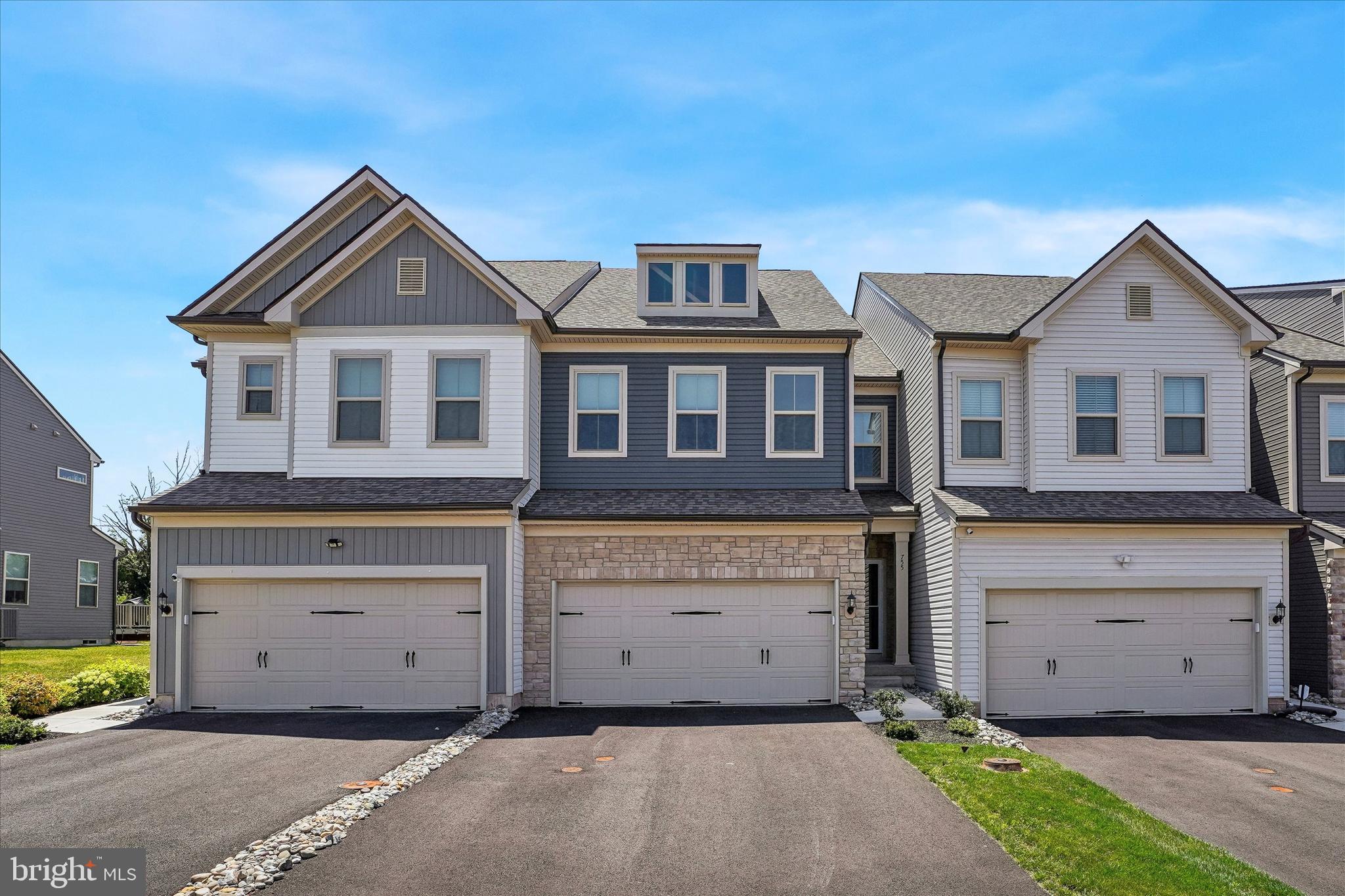 This 2024-built carriage home has everything you want from new constructions without the wait.   You can be moved in before the school year begins! Offering an upgraded extended floorplan on all levels for added square footage and an exceptional sense of space. Wide plank luxury flooring, 9’ ceilings, abundant natural light, and a modern, open floorplan define the main level.
The kitchen features quartz countertops, stainless steel appliances, gas cooking with an exterior vented hood, crown molded cabinetry, and pendant lighting over a large island with seating for four. The kitchen, dining area, sunroom, and living room flow seamlessly. Ideal for everyday living and entertaining. Step outside to the maintenance free composite deck, perfect for grilling or morning coffee.
Upstairs, the main bedroom suite includes a generous walk-in closet, bonus sitting room, and private bath with dual vanity, linen closet, and oversized shower. Two additional bedrooms offer ample space and storage, and the second full bath includes dual vanity and tub/shower combination. 
The full basement provides outstanding potential for future finishing, featuring high ceilings, an egress window, and rough plumbing for an additional bathroom.
Additional highlights include; upgraded recessed lighting throughout, high efficiency gas heat, tankless water heater, electric vehicle charging outlet in the two-car garage, lawn care and trash removal covered by HOA and more. With its fresh, neutral palette and thoughtful upgrades, this home is truly move in ready.
