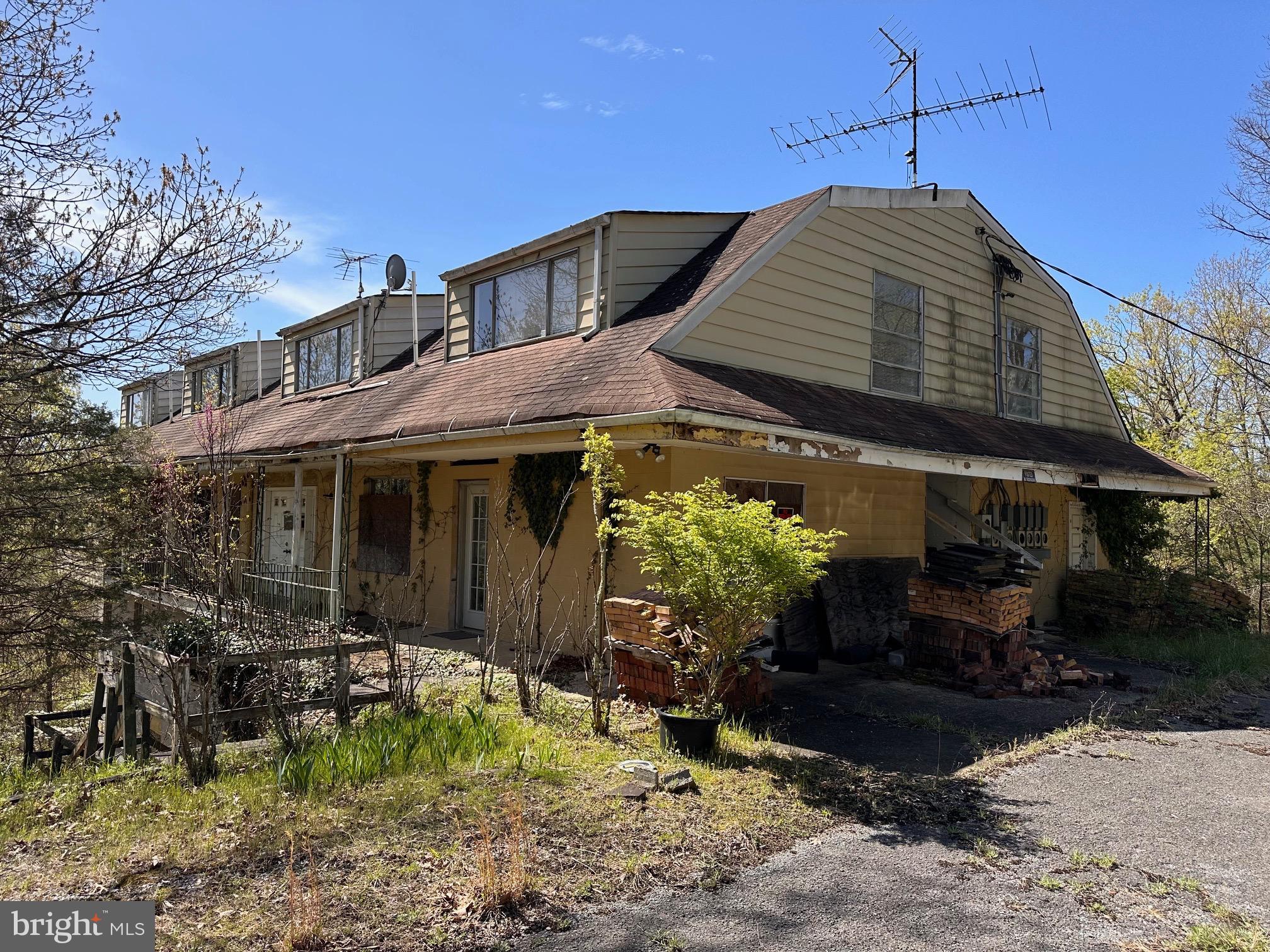 Great possibilities on this large, multifamily property. Could be changed into a single family home also.  Beautiful views from the top.   Paved driveway leading up.  Five levels of building!  Private well and septic system.  Property needs a great deal of rehab, but could be something spectacular.  Previous use was to rent rooms, some had kitchenettes, and there was a large room with a kitchen.  Bedroom and bathroom numbers are approximate with what is there currently.  There are two large garage doors also into the lower levels.  Quiet and peaceful location with many woods and a picnic area.