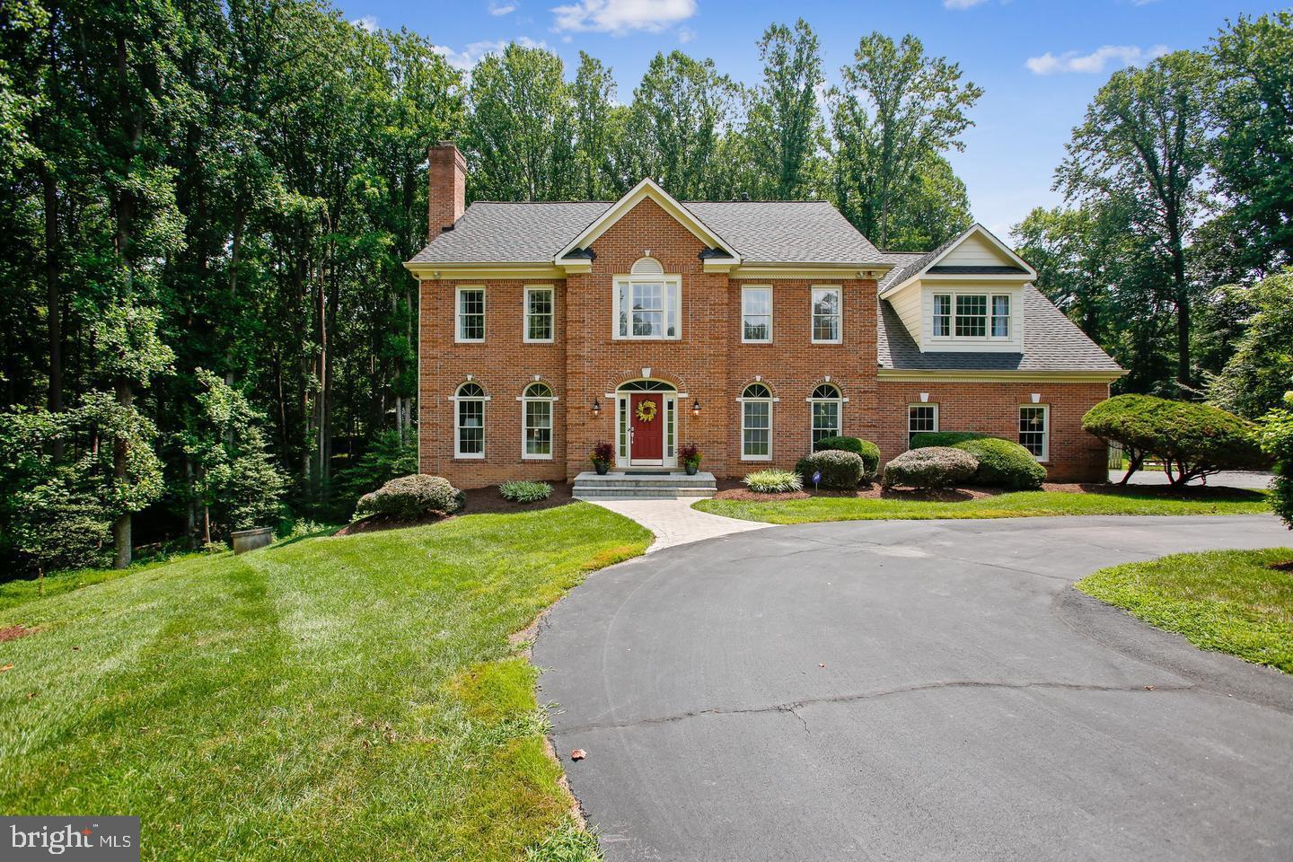 Perfection! Impeccably sited on over 2.5 Acres of Wooded Privacy at the end of an Oakton Cul de Sac, this 6 Bedroom 5.5 Bath home offers roughly 6150 square feet of comfortable and updated space on three comfortable levels. A large welcoming foyer ushers you in with creamy tile and an elegant curved hardwood staircase. Stylish, updated details are found throughout the home.The main level offers a lovely blend of large, formally defined rooms (living room and dining room and main-level study) and wide openness at the rear of the home, revealing an expansive, well appointed kitchen with stainless steel appliances, breakfast room and great room vista, for practical living. Beautiful architectural details abound, including arched entries and transoms, deep dentil molding, built in bookcases and 2 warm and inviting fireplaces, which adorn the living room and great room. Two staircases unite the main and upper levels. The dining room and formal living room are ideal for entertaining. Almost every room beckons you outdoors with idyllic views through expansive French doors onto decks or the screened porch. The great room offers a cathedral ceiling, access to the deck and a screened porch and a second staircase to the upper level, as well as a wood burning fireplace. A laundry room (1 of 2) and powder room complete the main level. The upper level offers 4 generous bedrooms including a spacious owner's suite. This suite offers a generous bedroom, dressing room, walk in closet and a stylishly updated spa-like bath with seamless shower and modern stand alone tub. A second suite features a cathedral ceiling and private bath. Two other bedrooms share a buddy bath (each ejoy their own private vanity however). The walk-out lower level is expansive and offers endless stylishly renovated space and includes a family room, in-law suite, bedroom and den/bonus room, laundry, mudroom & two full baths. Two bedrooms , each with its own full bath. The family room offers space for play or TV viewing, and a wet bar is a perfect combination for all sorts of entertaining.