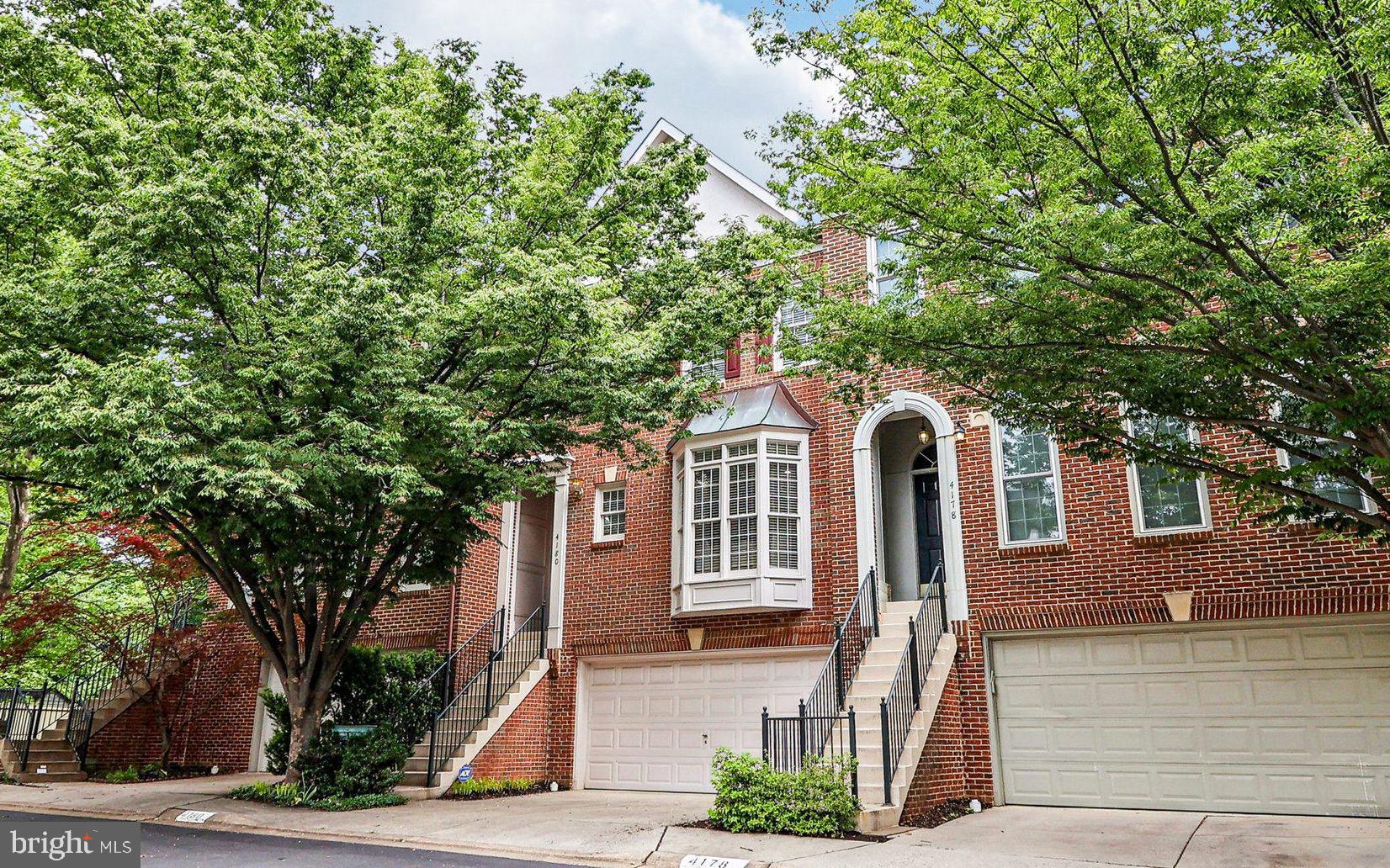 Beautifully maintained 3-level brick townhome with a 2-car garage in the highly desirable Chancery Square community of Fairfax City! This spacious home offers nearly 2,800 square feet of updated, comfortable living space. The main level features an open-concept living and dining room with hardwood floors, crown molding, elegant pillars, and vaulted ceilings. Relax by the gas fireplace or step out to your private rear deck—perfect for morning coffee, al fresco dining, or evening unwinding. The bright kitchen includes stainless steel appliances, ample cabinetry, a pantry, and a cheerful breakfast nook. Upstairs, the primary suite impresses with vaulted ceilings, a large walk-in closet, and a spa-like ensuite bath complete with dual vanities, a soaking tub, and a separate shower. Two additional bedrooms offer generous closet space and share a full hall bath. The walkout lower level features a spacious rec room, half bath, laundry room, and opens to a beautifully landscaped, fully fenced flagstone patio, perfect for entertaining guests or enjoying peaceful, private evenings at home. With fresh paint, updated lighting, brand-new carpet throughout, this home is truly move-in ready and waiting for your personal touch. Just blocks from the heart of Fairfax City, enjoy walkable access to shops, restaurants, coffee houses, breweries, the farmers market, and community events. You're also within walking distance of George Mason University, with performances at the Center for the Arts and events at EagleBank Arena nearby. Commuters will appreciate easy access to Rt 50, Rt 29, I-66, and the Vienna Metro, with a Metrobus stop located at the neighborhood entrance. This home combines the space and comfort of a single-family with the ease of low-maintenance townhome living—right in the center of it all.