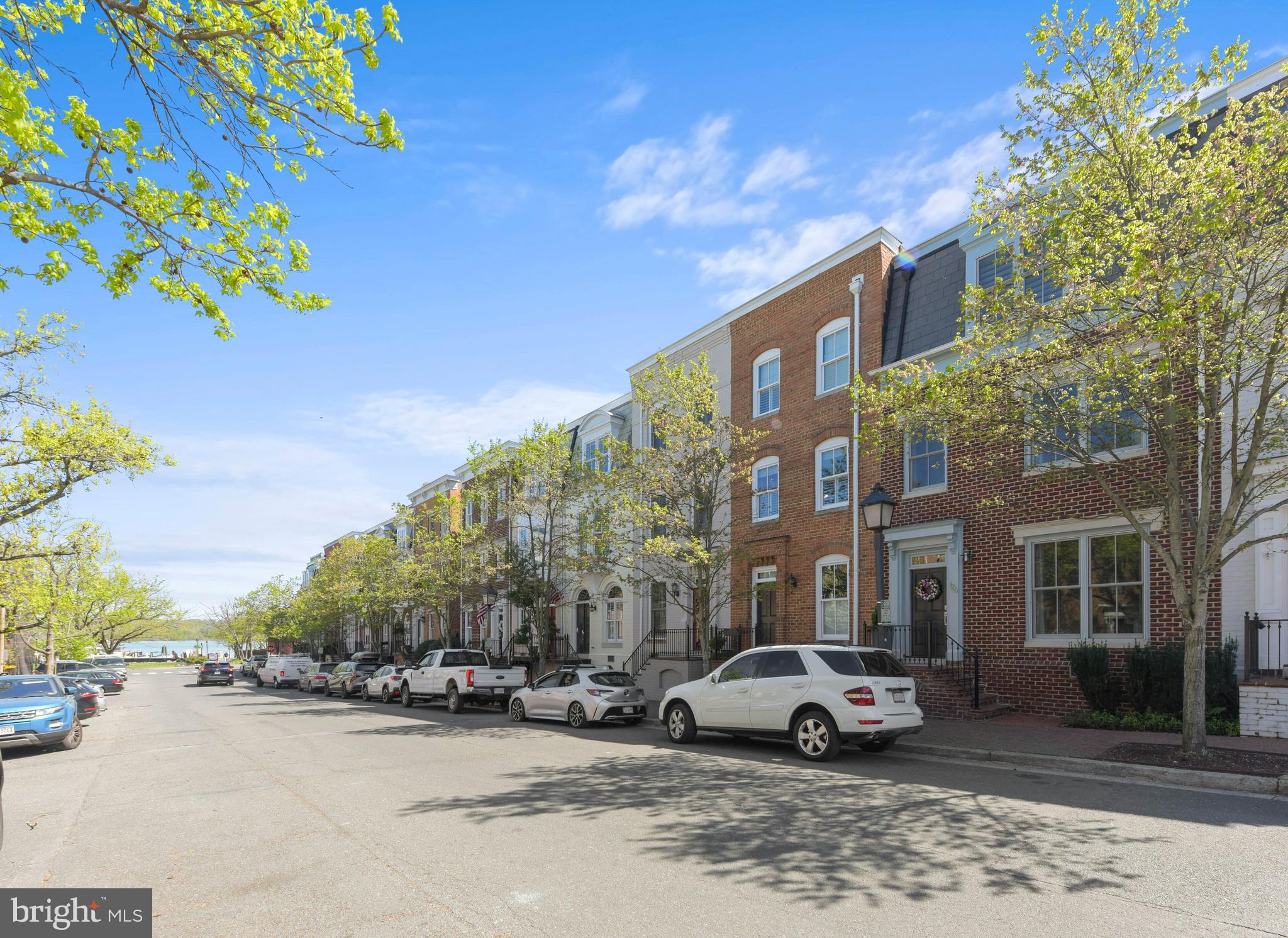 Welcome to today’s hallmark of luxury living at this enviable address just steps to the picturesque waterfront in charming historic Old Town of Alexandria City, nominated six years in a row for the Condé Nast Traveler Readers’ Choice Awards.  Beautifully renovated with an elegant modern sensibility, this splendid townhome with abundant curb appeal offers delightful glimpses of the Potomac River from its front stoop, a lovely private stone patio, two coveted off street parking spaces right out back and three levels of spacious upscale interior designed to wow!  Cosmopolitan glamour highlights the entry level perfect for entertaining with its high ceiling and open flow from the living room anchored by a gorgeous contemporary linear gas fireplace to the dining room illuminated by a handcrafted glass pendant to the large gourmet kitchen with a cheerful breakfast nook and a cozy lounge opening to the gated patio for easy alfresco dining.  Stylish comfort infuses the second level featuring a sumptuous primary suite with two walk-in closets, custom storage with hidden hamper, double vanity, walk in shower and wet bar paired with an inviting family room on the front with a second fireplace for a private retreat or casual gatherings.  Sweet serenity awaits on the top level featuring two generously sized bedrooms, each with an ensuite bath, laundry room with built in storage, and skylight in the hallway to amplify natural light exposure.  Say hello to beautiful sunrise on the Potomac and take a leisurely walk to the vibrant downtown marina with water taxi services to Georgetown, The Wharf in DC, National Harbor and stadiums across the river to watch the Nationals and D.C United play.  Come celebrate your arrival at the best of Old Town living surrounded by green space galore from Founders Park down the block to Rivergate Park on the north and Jones Point Park on the south and yet just an easy stroll to a treasure trove of local attractions and events including historic sites, art galleries, unique boutiques, fun shops, farmer's market, popular eateries, high end restaurants, street performances, festivals, parades and more to discover.  Cheers to your fabulous new home at 126 Queen St. in Old Town Alexandria!  Enjoy interactive virtual tour with floor plans.  Open Sunday from 2:00 to 4:00 pm.