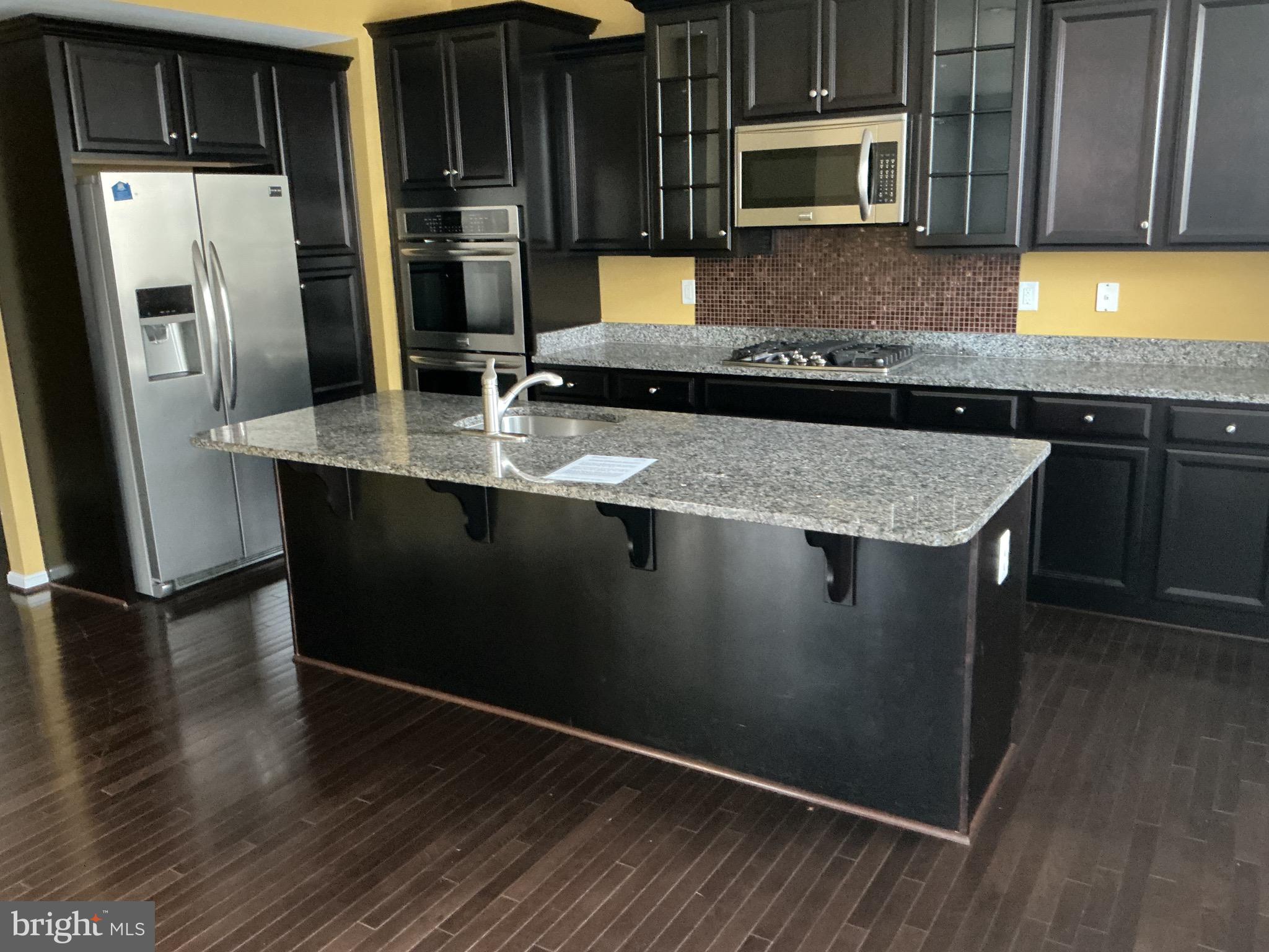 Built in 2015, this is a short sale, sales price must be approved by the bank. With over 75 successful settlements with short sale sellers. Expect a settlement in the 60 to 90 day time period. This exquisite home has 5 bedrooms,  3 and 1/2 baths, fenced back yard and over 4,000 finished square foot of living space. Cherry wood flooring throughout most of the house with bedrooms with carpet.  Located just 300 feet from community clubhouse and pool. Just a 2 mile ride to new Carrolton metro stop. Listing agent with over 75 successful short sales completed.  Home shows very well!