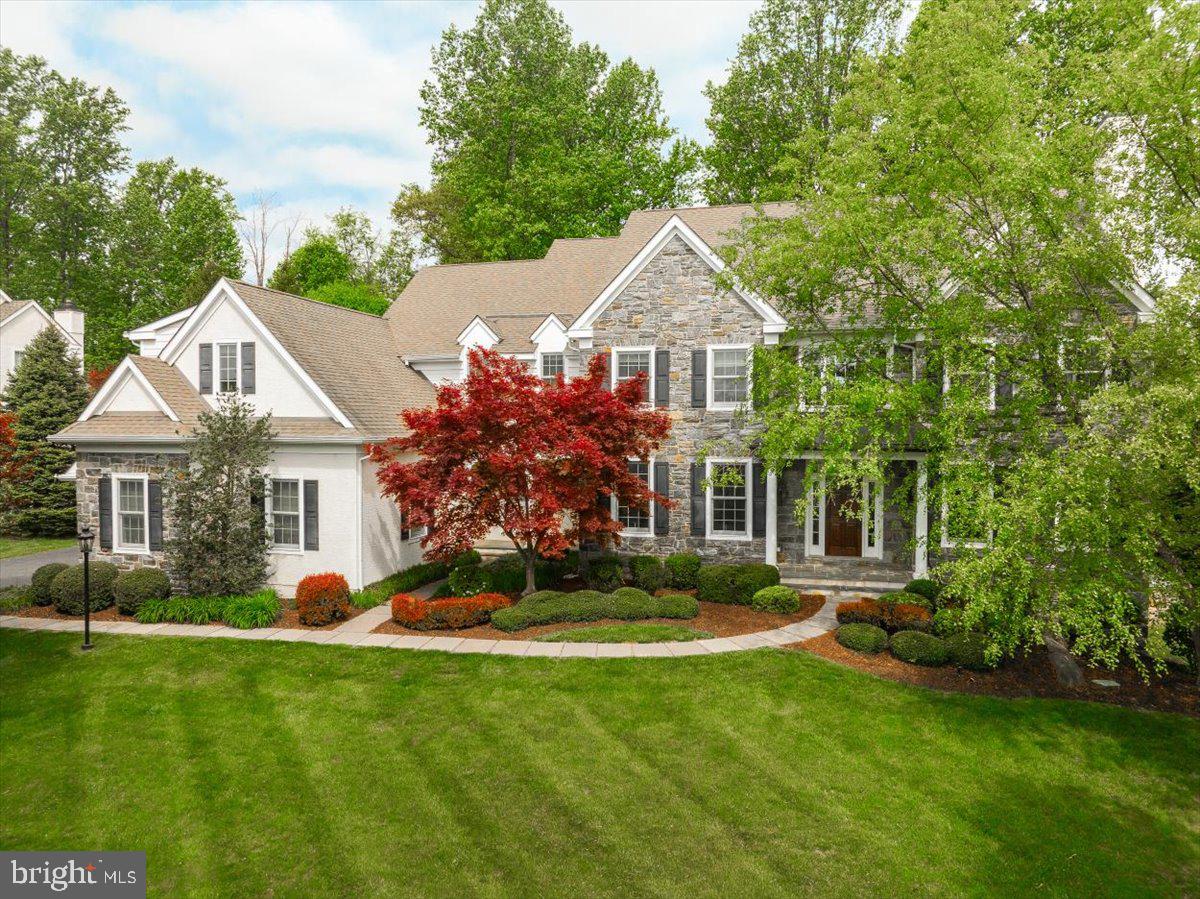 This beautiful 2-story stone farmhouse-style home represents one of the finest of Brick House Farm properties.  Lovingly maintained by its original owners this home is dramatically positioned on a landscaped lot with mature trees.  It has many architectural features including beautiful millwork, hardwood floors and large windows that bring in lots of light even on a cloudy day!  Some 1st floor  amenities include formal living and dining rooms. Formal study plus a working office, two powder rooms, butler pantry, gourmet kitchen that opens to breakfast room & family room. Rear glass doors that open to the rear deck. Mudroom that has an outside exit plus it opens to the 3 car garage. The 2nd floor Main Suite  includes a sitting room, 2 walk-in closets, large main bath with 2 separate vanities, tile shower and soaking tub.  There are 3 guest bedrooms; 2 are connected Jack & Jill style, with large closets and a 3rd with its own private bathroom. A large 2nd floor laundry room with a door to access a large, floored attic - great for storage!  There is also a back staircase that takes you from the 2nd floor down to the kitchen area.  The basement is ginormous! A large portion of it is finished with a built-in bar, bathroom, exercise room, extra large storage room & outside exit to the side yard.  The HOA covers septic clean-out annually as well as maintenance of open space.  Walking trail to a pond and a picnic area under a gazebo for neighborhood get togethers.  The owners took real good care of this home, it is beautiful, clean and move-in ready!  Easy to show - easy to love!