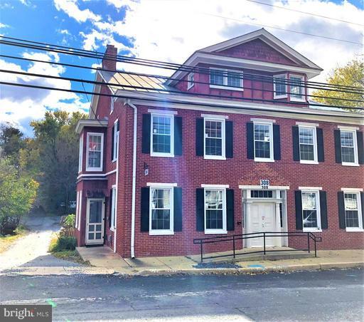 MASSIVE RENOVATED BRICK COLONIAL right in small town Middletown.  This GRAND SOLID BRICK home offers random width Heart Pine wood floors & 10' Ceilings! Gorgeous trim & lots of original features such as charming staircases & exposed interior brick/wood beams!  Huge eat-in country kitchen with stainless appliances & a Giant master suite with super bath!  Special Zoning perfect for home or business use!!!  HUGE 3rd story was used as living space years ago.  Tremendous possibilities to finish into additional space! 1 BR In-law suite/apartment on lower level.   You could rent the apartment to help pay your mortgage!  Possibility of 1st floor master!  Plenty of room in half bath to covert to FB.  This home has an abundant amount of entertaining areas with its 2 sizable sun porches, large back deck, fenced yard, & so much more!