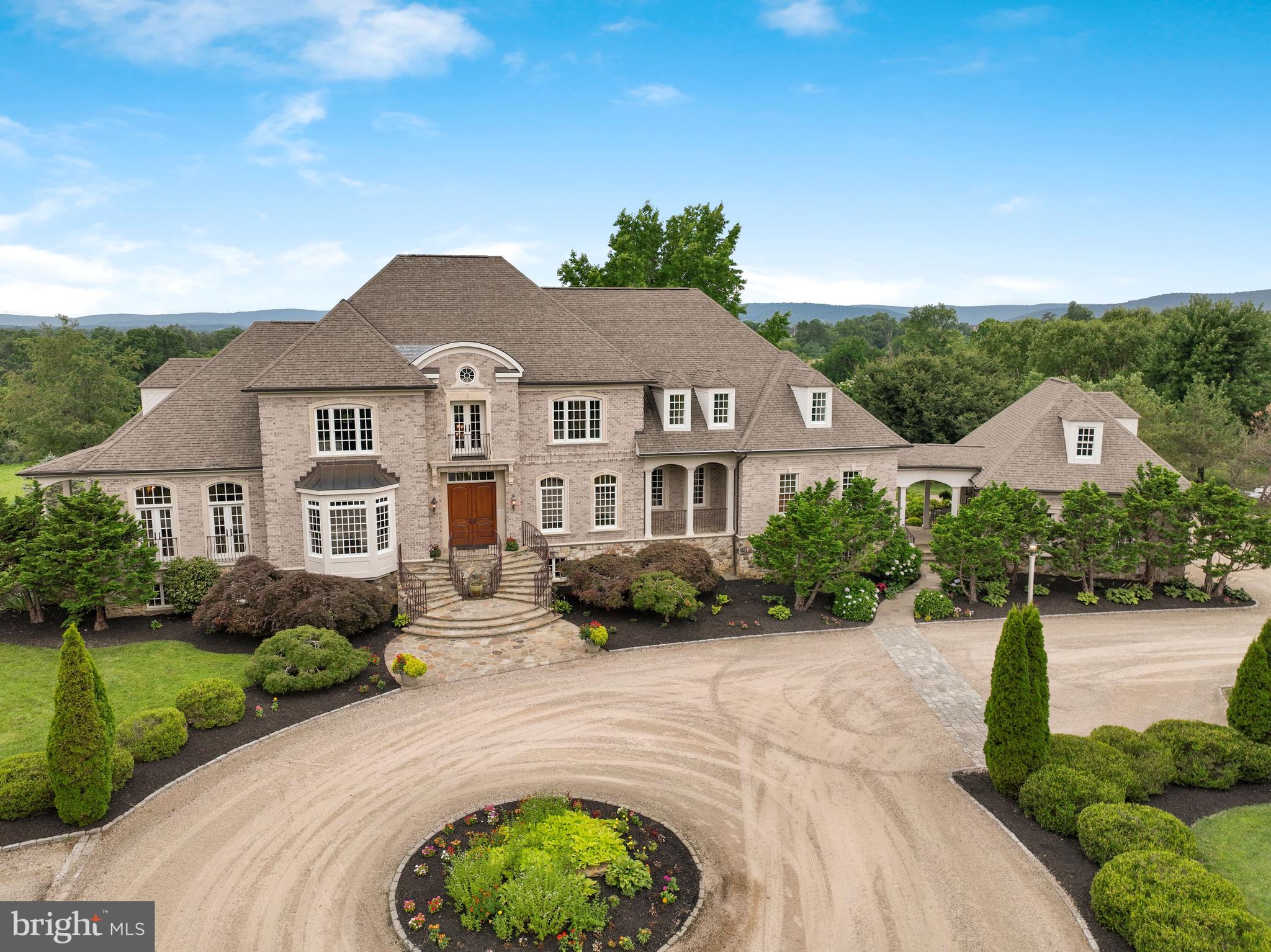 Welcome to 16017 Hampton Rd - nestled in a bucolic paradise, this once-in-a-lifetime Grand French Country estate on the hill boasts 16 +/-acres. This elegant, custom 9800+ square foot/5 bedroom/7 full bath/2 half bath home has it all — beauty, privacy, panoramic views, spectacular outdoor pool, 3-level barn/workshop, extensive hardscape & masonry, and close proximity to downtown Hamilton, Purcellville, & Leesburg. Built in 2007, this home has been meticulously maintained and dearly loved. Sitting stately atop a hill, in a private neighborhood of other custom, multi-million dollar, large-acreage homes. The interior of this home is as stunning as the exterior with beautiful finishes, high-end trimwork, vaulted ceilings, Brazilian Cherry hardwood floors, and woodwork throughout the home sourced onsite and from the original old barn. Designed for elegance, yet comfortable living —each spacious bedroom its outfitted with their own walk-in closets, built-in shelving, and en-suite bathrooms. The primary bath and kitchen have heated floors to add to the cozy living during the colder months. For those who love to entertain, this beautiful home does not disappoint, offering large spaces with terrific flow and custom touches throughout. The gourmet kitchen boasts a huge center island; plenty of space to keep the chef happy! Top-of-the-line appliances include 60” Wolf range,  double subzero refrigerators, and 2 dishwashers. First floor office with custom hard pine built-ins provides a wonderful work-from-home space. On the main level,  you'll find an enormous primary suite with it’s own private outdoor terrace, dual-sided gas fireplace to heat the primary bath while you relax in the deep jet-tub. The spacious primary-walk in offers plenty of space for his/hers and has a it’s own wine fridge for late night toasts! A beautiful finished basement has walkout access to the back patio and includes a large rec room with bar area, entertainment room, exercise room, a therapeutic sauna, a bonus room, and two full baths. A rare and special place, this is a house to build a lifetime of memories. Property is in land use. Seller not responsible for rollback taxes.