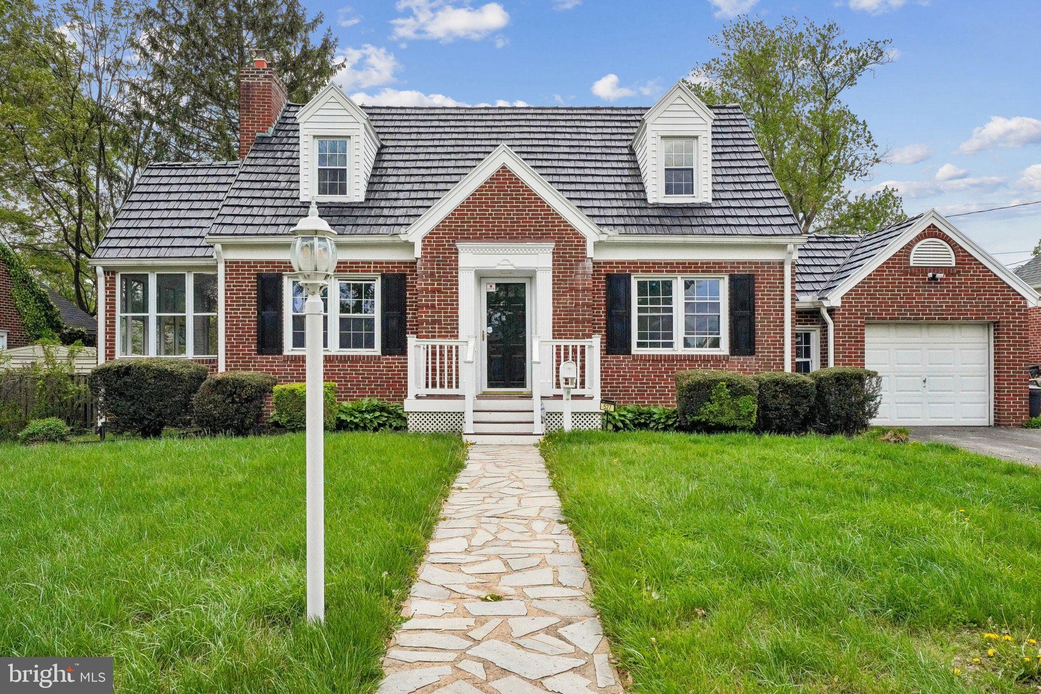 This charming renovated, brick Cape Cod with three bedrooms, four full baths and a side-sunroom, is perfectly situated on a great lot in a prime location with easy access to Routes 195, 295, 695, and 170. The exterior features excellent curb appeal –  professional landscaping, a level, fenced backyard and off-street parking. The interior boasts fresh paint throughout, crown and chair rail molding, arched doorways and a seamless flow of new and refinished hardwood floors. The main-level layout includes a versatile bedroom and a modern full hall bath. The kitchen has been refreshed with new quartz countertops, white cabinetry with matte black knobs and black appliances, while the living room offers a cozy gas fireplace. Upstairs, there are two spacious bedrooms and two additional full baths, including a primary suite with a private ensuite. The living space extends to the finished walk-up lower level, which provides a rec room with new carpet and an updated fourth full bathroom. Complete with durable Trex front and rear porches, a patio, a synthetic roof with oversized gutters and a one-car garage connected by a convenient breezeway, this home offers a solid, move-in-ready layout in an excellent commuter location