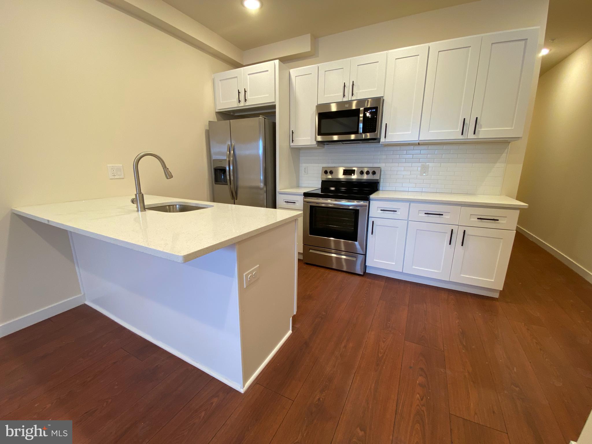 Fully rehabbed apartment building in the Kingsessing section of Philadelphia located at 52nd & Chester is now accepting rental applications. Unit consist of 2 & 3 bedrooms, and offer unmatched designs and pricing. All units come standard with 5-1/2" plank hardwood flooring, stainless steel appliances, central A/C, washer and dryer (in-unit), coffered and accent wall designs, intercom and e-keypad access, and so much more! Specific unit listed is located on first floor, has private entrance, basement access for storage with full-size washer and dryer, and much more.