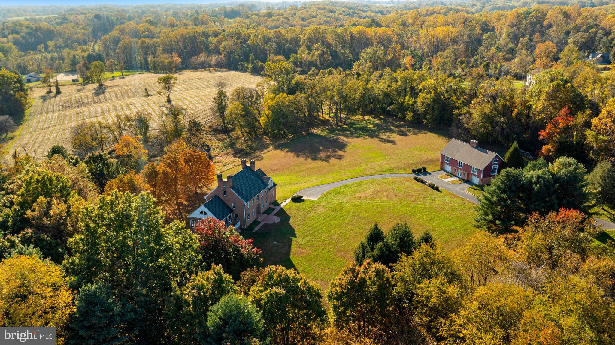 Do you value your privacy, yet need a convenient location?  This is the perfect home and setting for living the country livestyle dream in Northern Baltimore County.  Pursue your passion on these 35 acres with amazing views of Long Green Valley.   20 acres of pasture and 15 acres of woods.   This quality-built home is reminiscent of the past with beautiful moldings, hardwood floors and high ceilings.  Every detail carefully selected and quality crafted.  Generous room sizes.  Lots of windows for a bright and airy feel and views from every room.  Gracious formal living and dining rooms but wait until you walk into the sunroom with soaring cathedral ceiling and long windows on 3 sides-you’ll be hooked!  Cozy up by one of 4 wood-burning fireplaces-winters coming!  Or take a long soak in the primary bath with all the whistles and bells. Primary bedroom features cathedral ceilings too.  As a bonus the detached shop/garage includes a finished space above and full bath..  It would make a great space for a studio, office and more.  These 35 acres also include one deed additional building right.  Or maybe you are thinking of horses, cows, or chickens! Call for your private tour.