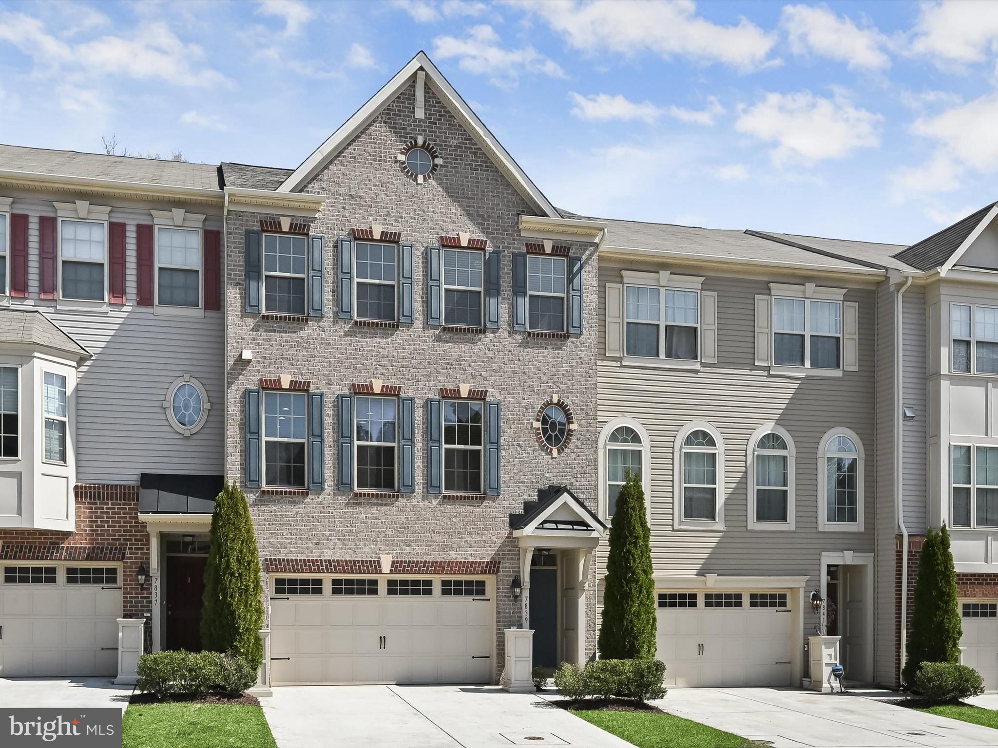 This stunning three-level brick-front townhome offers both style and convenience in a prime commuter location. With a two-car garage and a three-level bump-out, this home provides expanded living space and backs to serene, wooded views for added privacy.
Step inside to an open-concept main level, where hardwood flooring, lofty windows, and abundant natural light create a warm and inviting atmosphere. The kitchen, perfectly positioned between the living and dining rooms, boasts 42-inch cabinetry with roll-out shelves, stainless steel appliances—including a gas range—and an expansive island with a breakfast bar. The adjoining dining room offers plenty of space for gatherings, while the generously sized living room provides a comfortable place to relax. A bright sunroom, accented by pendant lighting, leads to the deck through sliding glass doors, seamlessly blending indoor and outdoor living.
Upstairs, the primary suite is a true retreat, featuring a vaulted ceiling, a cozy sitting area overlooking the trees, and a walk-in closet. The en-suite bath is designed for luxury with a double vanity, a soaking tub, and a tiled shower with a mosaic inlay. Two additional bedrooms, also with vaulted ceilings, share a well-appointed full bath with a linen closet. A conveniently located laundry room completes the upper level.
The lower level extends the home’s versatility with a spacious family room, full bath, direct access to the garage, and a sliding glass door leading to the patio. Whether used as a second living area, home office, or entertainment space, this level enhances the home’s functionality.
Residents enjoy access to the community pool, perfect for warm summer days. Ideally situated near major commuter routes, including MD-295 and Route 32, this home is just minutes from the MARC train station and BWI Airport, making travel effortless. With thoughtful design, ample space, and an unbeatable location, this townhome is a rare find!