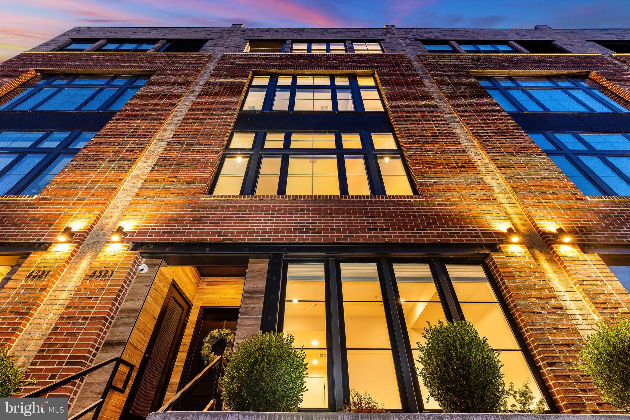 Positioned along both the Schuylkill River and the Manayunk Canal, this five-bedroom, five-level townhome is one of only two buildings in the sensational Locks community with unobstructed dual-water views and approx. 5 Years Left on the TAX ABATEMENT.  The home is wrapped in floor-to-ceiling, 8-foot windows that capture natural light and water views on every level. Wide-plank hardwood flooring runs throughout, and a private elevator provides seamless access to all floors. The entry level includes a TWO-CAR GARAGE with EV charger, multiple storage closets, and a flexible bonus space suitable for a gym, studio, or additional living area. The main living level features an open-concept layout anchored by an eat-in kitchen with quartz countertops, oversized center island, pantry storage, and premium appliances including a Sub-Zero refrigerator, 6-burner Wolf gas range with built-in hood, and Wolf drawer microwave. The home has two separate living and family rooms, providing plentiful space to entertain, including a dry bar with beverage refrigerator, a separate dining area, and a conveniently located powder room. The third level offers three bedrooms, including one with an ensuite bath featuring a glass-enclosed tiled shower, along with a bathroom with dual-sink vanity. and tub/shower combination. A dedicated laundry room is also located on this level. The entire fourth floor is dedicated to the primary suite, featuring a bedroom with river views, a walk-in closet, custom white gloss built-in cabinetry, and a private office or optional fifth bedroom. The spa-inspired primary bath includes a soaking tub positioned to capture water views and a glass-enclosed shower with dual shower heads, rain shower, handheld wand, and built-in bench. This level also includes a wet bar with wine refrigerator and an outdoor seating area directly off the suite. A rooftop terrace crowns the home with unobstructed panoramic views of both the river and canal. Designed for entertaining, the terrace features built-in SONOS speakers and is pre-wired for an outdoor television. Additional features include SONOS ceiling speakers in the kitchen, family room, primary suite, and rooftop terrace; Lutron programmable electric shades; smart door locks; smart thermostat; and elevator access to every level. The home is adjacent to a community parking lot, providing convenient guest parking. There is also bridge access to Main Street, which is only a few short minutes away. Located along the Manayunk Canal and Tow Path Trail, the home offers direct access to scenic riverfront walking and biking paths, with close proximity to Main Street Manayunk’s restaurants, cafés, galleries, and shops, including Pilgrim Roasters, The Goat’s Beard, Winnie’s, Jake & Cooper’s, and La Colombe Coffee. Nearby recreational anchors include Pretzel Park and the Schuylkill River Trail. The Manayunk SEPTA Regional Rail station provides service to Center City Philadelphia in approximately <25 minutes. Convenient access to I-76 connects quickly to I-676 and I-95, offering efficient routes to Old City, Society Hill, and Philadelphia International Airport, as well as north–south travel along the Delaware River corridor. (Second level with kitchen and primary level have been recently freshly painted white)