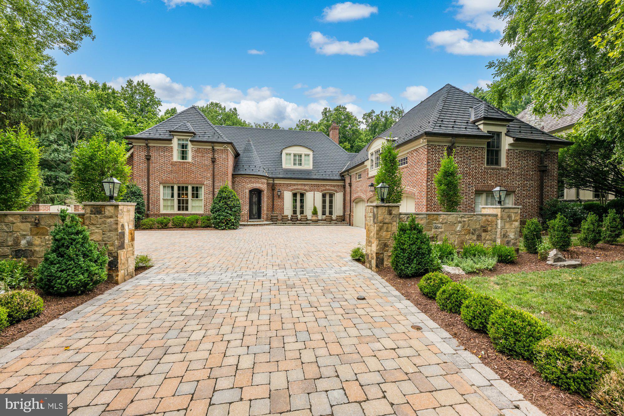 This custom-built, Flemish-bond brick Normandy-style home was built in 2000 by Jeffco and designed by notable architect Donald Lococo. Venetian plaster walls, custom millwork, and newly refinished hardwood floors are some of the meticulously curated features throughout this impressive home. The kitchen has been renovated and outfitted with Rutt cabinetry, Wolf commercial grade range with custom made vent hood, paneled SubZero refrigerator, oversized pantry, and gorgeous quartz countertops. The main level boasts an open floor plan with french doors leading to a large slate terrace with pool and open air porch with stone fireplace. The grand living and dining room feature a coffered ceiling and a wood burning fireplace. Additional features of this impressive offering include 7 bedrooms, 6 full bathrooms, and 2 half bathrooms, an ample lower-level rec room with an additional living suite, a home gym, a large club/media room, a first-floor guest suite with a private bathroom, a heated three car garage hardwired with EV charging, and a motor court with stone pavers. $500K+ in recent improvements. Nestled in a quiet cul-de-sac backing wooded preserved land, in the prestigious and gated section of Avenel known as Rapley Preserve. This highly regarded neighborhood offers numerous amenities such as a gated entry with a guardhouse, equestrian center, golf, swim and tennis club, scenic bike, walking paths, sports fields, and playgrounds, all within a short commute to downtown DC, Bethesda, and Tyson’s Corner.