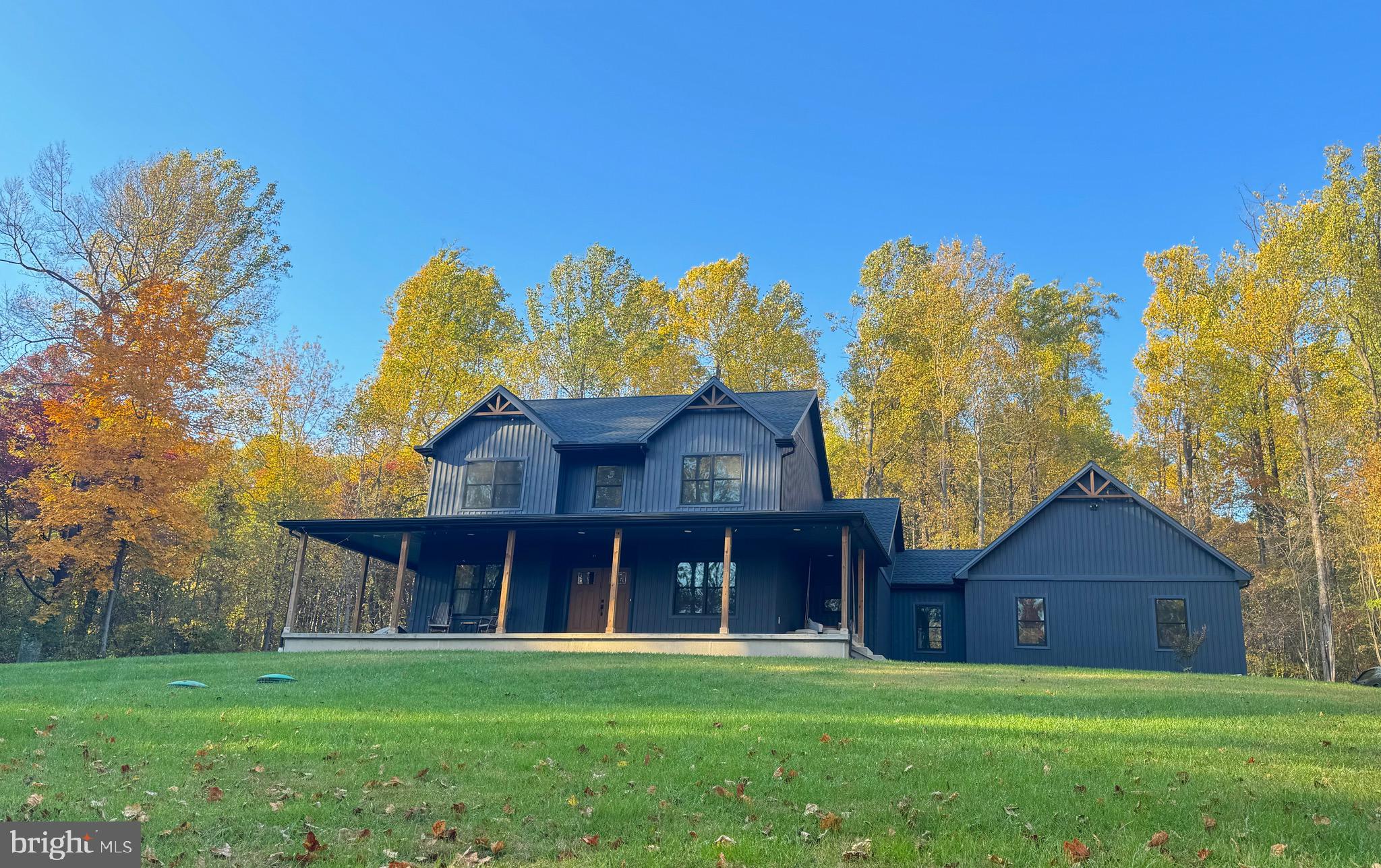 Welcome to your dream home! Nestled on almost 4.5 scenic acres in Thurmont, MD. This property is perfect for nature lovers or anyone seeking tranquility and privacy. While still being just minutes from Rt 15 and the quaint town of Thurmont. From the moment you step in the door you'll be greeted by a bright and airy space filled with natural light and high-quality custom features throughout. The focal point of the living area is a gas fireplace wrapped in stone from the floor to the vaulted ceiling, that combined with the oversized windows the natural light just pours in enhancing the warm and inviting atmosphere. Flowing seamlessly into the gourmet kitchen, you will find custom cabinetry with flawless granite counter tops, and stainless steel appliances. Throughout the home you'll find durable LVP flooring that offers style and resilience. The three full bathrooms each feature a ceramic tile floor, ensuring durability while keeping a modern look. The first floor primary suite serves as a serene retreat filled with natural light provided by your French doors leading to a large, lush backyard, a walk-in closet with plenty of storage space all around, and a spa-like en-suite bathroom. The primary bath is designed with a large, enclosed glass shower with two shower heads and a double vanity, combining luxury and practicality. Heading upstairs you'll find two additional bedrooms that provide generous space each with their own closet. They both provide lots of natural light with views of the front yard leading into the woods enhancing the serene feel. Beneath the main floor you'll find an unfinished basement offering a generous amount of storage space. The two-car attached garage is conveniently located on the side of the house providing easy access. The exterior provides a large, covered front porch complete with a porch swing perfect for enjoying those quiet mornings. Complete with a massive yard, it's an ideal setting for both tranquil solitude and vibrant outdoor gatherings. Located just minutes from nearby amenities, this home has so much to offer! You won't want to miss it. Schedule your private tour today and discover the home of your dreams!
