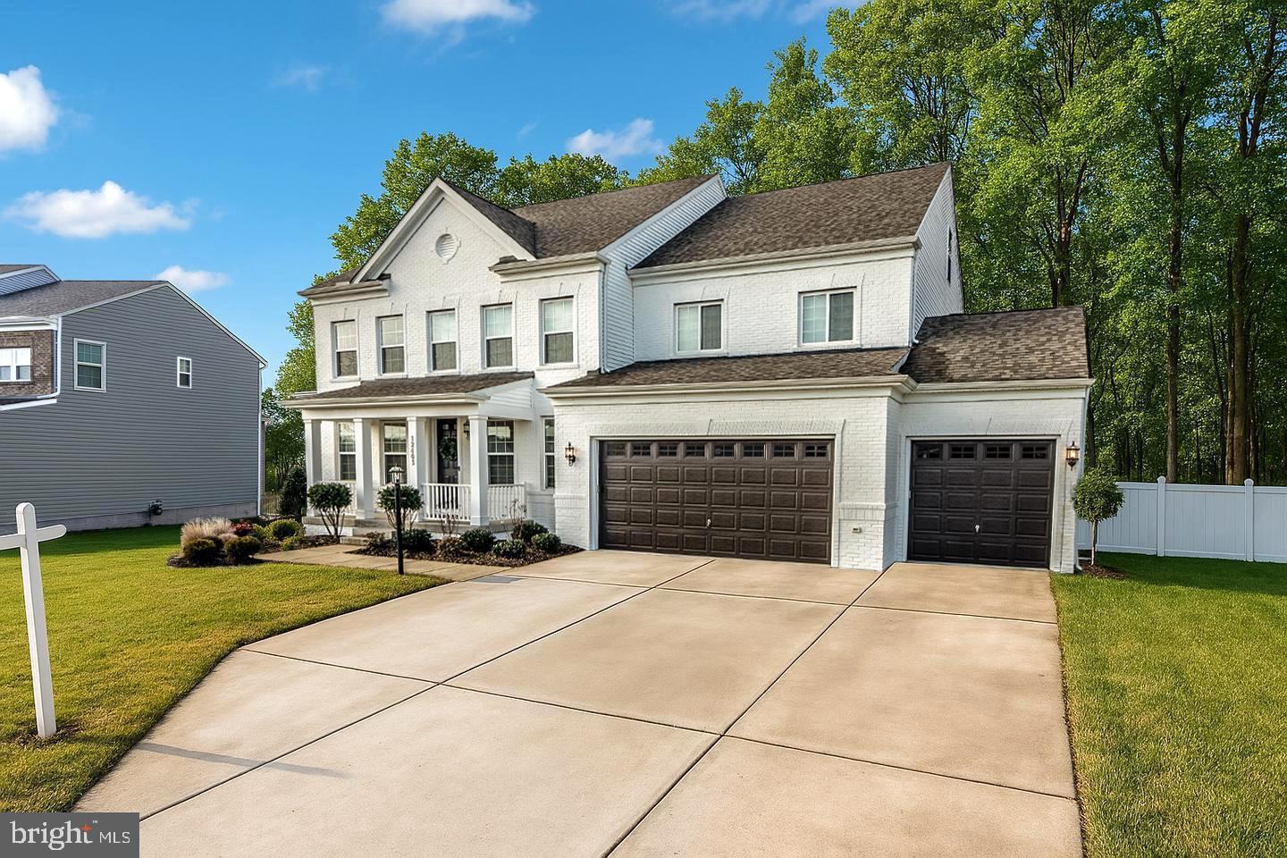 The owners are relocating and they’d never part with their dream home if they didn’t have to. Built just three years ago with nearly every available option from the builder, this home features a RARE three-car garage and a RARE fourth floor! With four levels of beautifully finished space, this home is impressively large and no expense has been spared. The loft is even pre-piped with full water hookups, ready for a future bathroom for the guest suite or a wet bar—perfect for entertaining during football games and parties!

Even after the home was built, the owners built-up the backyard with stunning hardscaping and an elevated screened-in terrace for enjoying dinner on warm summer evenings, mosquito-free!!! The gourmet kitchen features a massive island, double ovens, plenty of cabinetry, a walk-in pantry, even a convenient tucked away pocket office for mail or a quick email break. There is nothing you will want in a kitchen that this home does not offer.

The master suite is setup on the back of the house, so no road noise, and with protected conservation woods behind the property line this offers a rare opportunity for true privacy without having to fuss with shades and curtains and allowing you to take in the full sunrise and sunsets from the bedrooms south facing windows. Just outside the master bedroom, a princess suite offers a secondary private bathroom, and even a third bathroom in the hall for the children. The basement is huge, has a full bathroom, and has easy potential for an additional bedroom too, still with plenty of storage room! This home has everything. Nothing overlooked.

Other properties of this size and grandeur often come with costly HOA fees that fund extravagant amenities—like oversized swimming pools and aging facilities—that many homeowners rarely use. Here, the community takes a more thoughtful approach, offering well-maintained common areas, a rentable rec center for gatherings when you need it, even an outdoor park and a basketball court—without the burden of paying for amenities you won’t use.

Located literally less than 20 minutes from D.C. and 7 minutes to Andrews AFB, this home is new, large, private, rare, and perfectly situated. Perfect in every way.