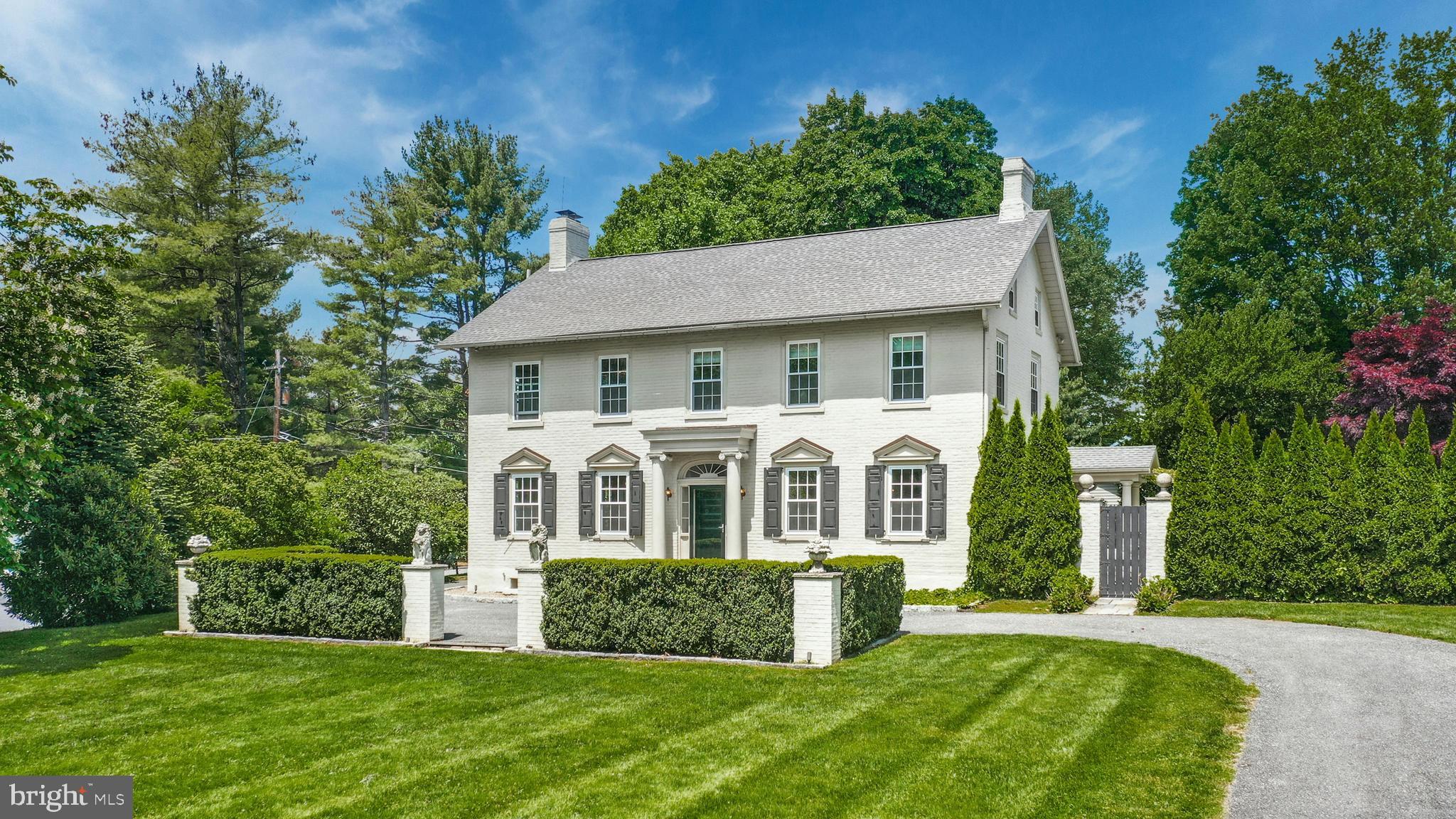A premier property on Bethlehem’s coveted Main Street extension, this beautiful Georgian colonial dates back to the city’s earliest days. Once belonging to the family that lent its name to Moreland Avenue, Moore Estate has been restored and remodeled, thoughtfully marrying form, function and history with wonderful updates. Recently renovated, the primary bath has Carrara marble floors, vanity and a custom glasswork shower with marble tiles and antique brass. The current owners commissioned a historic restoration contractor to restore all wood flooring, doors and woodwork throughout the house.
A winding driveway with brick pillars is the introduction to this grand estate, with mature landscaping, high hedges and Belgian block trim. Deep-silled windows and antique lighting accent the gracious living room with fireplace, and dining room. A fabulous custom kitchen has lacquered cabinetry and high-end Miele appliances. A half bath and family room with laundry closet complete this level. Upstairs, the primary suite is luxurious with abundant windows adorned with brand new Belgian linen shades, and newly renovated marble bath. Three more large, recently renovated bedrooms are on this level, along with a well-appointed hall bath.
Outside, a covered patio leads a European-style oasis with bluestone terrace, built-in fountain and breathtaking, in-ground pool completed surrounded by ivy-covered fencing and brick pillars for ultimate privacy. A 3-car detached garage, wide lawn and garden shed are welcome amenities.