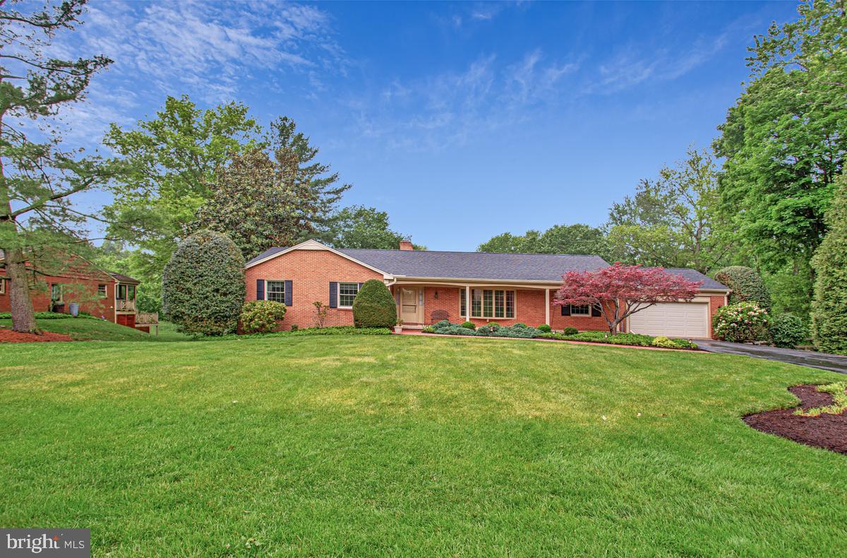 Nestled in the peaceful and highly desirable Dunloggin community, this sprawling custom brick rancher offers comfort, space, and an exceptional location close to top-rated Howard County schools. Designed for both everyday living and effortless entertaining, the heart of the home is the expansive kitchen featuring an adjoining breakfast area with a cozy gas fireplace, all opening to a stunning great room surrounded by walls of windows overlooking the tranquil backyard. Enjoy quiet mornings with coffee or unwind in the evenings on the relaxing screened porch or brick patio while taking in peaceful nature views. Greet visitors on the covered front porch & keep deliveries out of the weather; formal living and dining rooms provide elegant spaces for hosting gatherings and special occasions. The main level also includes three spacious bedrooms, two beautifully renovated bathrooms, convenient main-level laundry, and direct access to the oversized two-car garage. High-quality Renewal by Andersen windows & Pella doors enhance both comfort and efficiency. The walkout lower level offers incredible additional living space, including a bright recreation room with a handsome brick wood-burning fireplace & thoughtful bar/serving area with dishwasher & sink — the perfect setting for casual gatherings and making lasting memories with family and friends. A private den & connected full bath provides a quiet retreat for a home office, guest space, or hobbies. The lower level also features a second laundry area, abundant unfinished storage and workshop space, plus an additional walkout to the backyard for added convenience. New roof & skylight (2020); kitchen double oven / SubZero refrigeration (2023); Jenn-Air gas cooktop (2024); dishwasher (2025); main level Speed Queen washer/dryer (2025); GAS water heater (2018); HVAC system (2012)  Relish in all that this central Ellicott City location has to offer - parks, trails, lakes, restaurants, & shoppes or just stroll around the quiet streets of your new community for exercise & camaraderie with your neighbors.