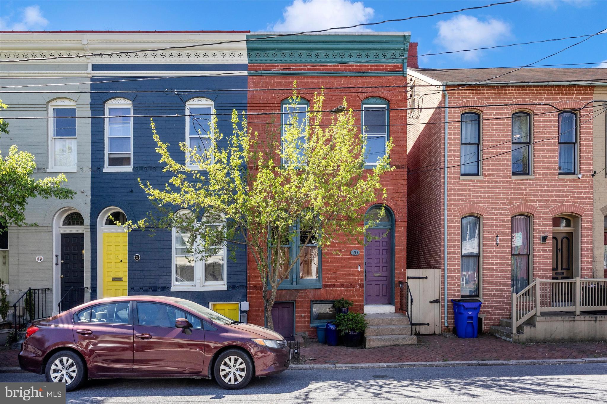 Historic Charm at a New Price!  Nestled on a quiet residential street in the heart of the Frederick Historic District, this 1900s Federal style rowhome blends historic character and modern updates with original hardwood floors throughout the home, curved walls and arched windows.  Walk down the street to the Farmers Market, vibrant art galleries and restaurants and enjoy all that City living has to offer in Frederick!  
The main level, with exposed brick and crown molding, offers an open floor plan flowing from the living room, dining room to the updated and sun-filled kitchen.  Everything has been freshly painted in neutral colors throughout the home. The kitchen has stainless steel appliances, granite counter tops, a gas stove with grill top and a separate butcher block workspace.  A bonus updated full bath, along with a washer/dryer, complete the main level.
Step outside to your backyard retreat featuring a brick patio with a deep fenced in backyard with a stone path leading to a firepit.  Perennial flowers will be popping up in time for Spring and Summer along with raised garden beds to grow your own vegetables and herbs.
Upstairs, you will find a spacious primary bedroom that overlooks the street from the front of the house and includes a large closet.  (Owner is offering the furniture outside of the sale of the home) The second bedroom also has a deep closet and the third bedroom is currently used as an office.  Access the porch from the third bedroom for your morning coffee and a beautiful view of your back yard oasis.   The full bath on this floor has also been updated.
The dry basement has a concrete floor, abundant storage space, a washing machine, sump pump and radon remediation system, for added peace of mind. 
This home is the ideal opportunity to enjoy the very best of downtown Frederick Living!