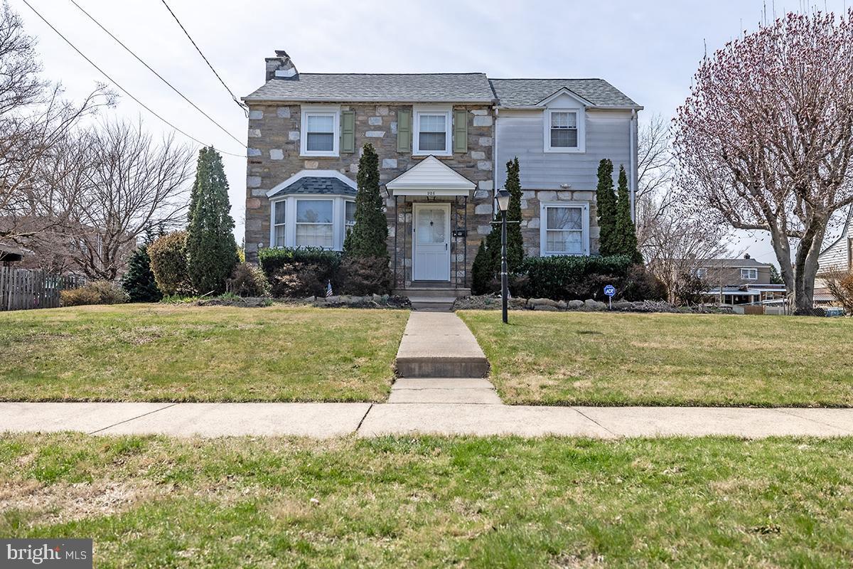 Welcome to this stunning home, filled with old-world charm and modern amenities, located on one of the prettiest streets in the highly sought-after Fox Chase neighborhood. This meticulously maintained  stone/brick & siding residence sits on a double lot, offering expansive outdoor space and timeless beauty.
As you enter, you'll be greeted by an abundance of natural light and a spacious foyer featuring crown molding, chair rail, parquet hardwood floors, and a deep hall closet. The extra-large living room boasts a brick wood-burning fireplace, bay window, crown molding, and rich parquet hardwood floors—perfect for both everyday living and entertaining. The formal dining room is elegant and inviting, with crown molding, chair rail, recessed lighting, and more beautiful parquet hardwood floors. The eat-in kitchen is both functional and stylish, with recessed lighting, newer hardwood cabinets, Corian counter-tops, and a convenient exit to the rear patio and yard. A powder room with utility sink offers additional convenience, as does the access to the basement. Upstairs, you’ll find three spacious bedrooms, all with recessed lighting, ample closet space, and a newly renovated hall bathroom. The en-suite has been updated with a glass-enclosed stall shower, chair rail, and ceramic tile flooring. There’s a hall linen closet and cedar closet. Enjoy your morning coffee on the deck, which overlooks the beautifully landscaped, over-sized backyard—ideal for gardening and outdoor enjoyment. The unfinished basement provides plenty of potential for additional living space, featuring a laundry area with washer, dryer, and utility tub. The home also includes a 50-gallon hot water heater, newer whole-house heater, updated 200-AMP service & a new roof! Additional highlights include an attached garage, an over-sized driveway, and plenty of windows in the basement for added light. The expansive front lawn and stunning landscaping, including mature shrubs and flowering crepe myrtle trees, make this a gardener's paradise.  You will find a newer garden shed in the rear yard  to hold all your gardening tools! Hardwood floors, recessed lighting, fresh paint, and plenty of light flow throughout the home, creating a warm and welcoming atmosphere. Architectural details like these are hard to find! Conveniently located near shopping, restaurants, and public transportation (just a 15-minute ride to Center City on the Fox Chase Line), this home offers both comfort and convenience. Plus, a 12-month home warranty is included for peace of mind. Don’t miss out on this rare opportunity to own a piece of history in one of Philadelphia's most desirable neighborhoods!